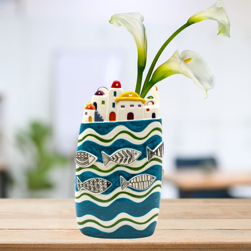 Large ceramic seaside village vase by My Italian Decor featuring painted coastal scene and white lilies.