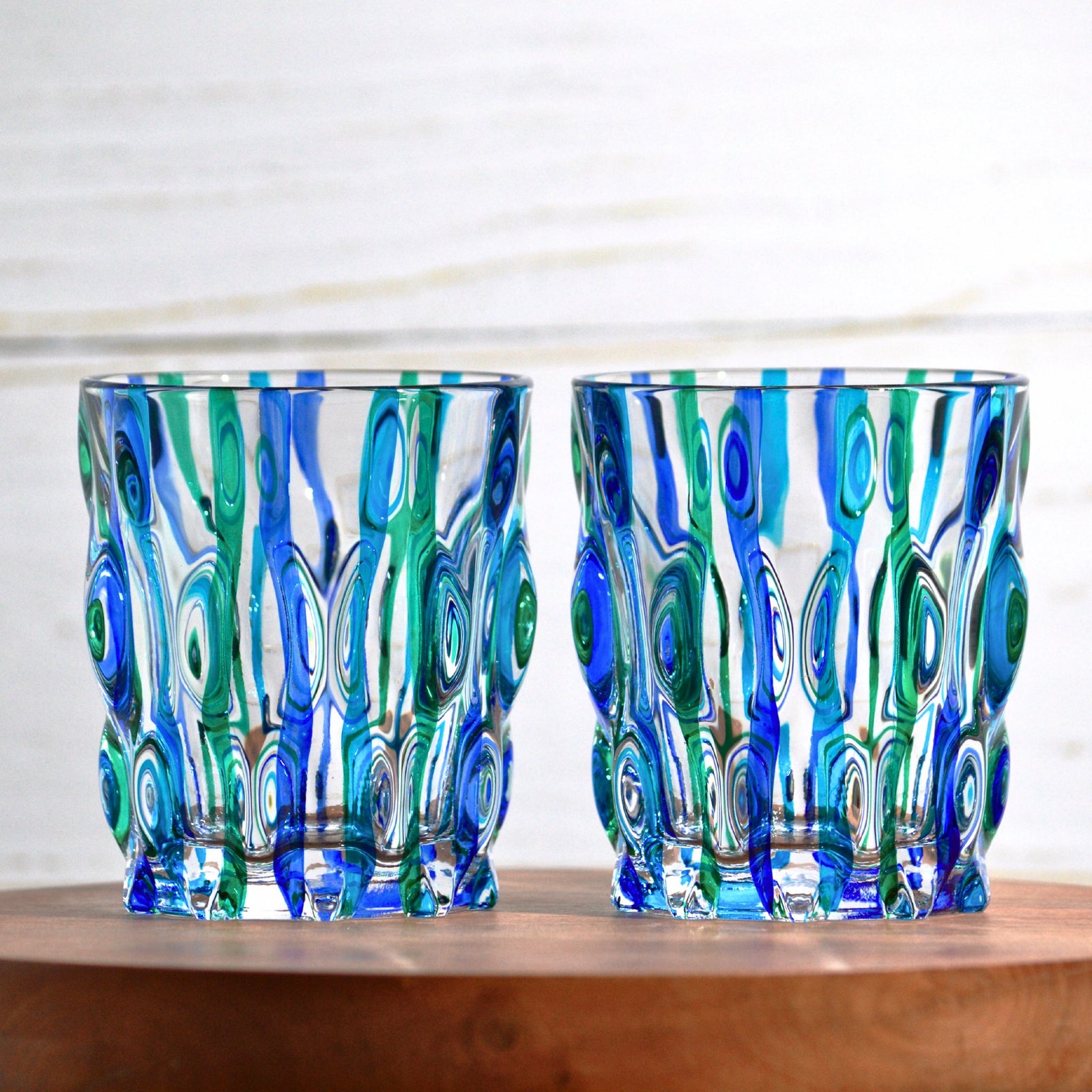 Set of two DZ Lyrical blue and green short drink tumblers made in Italy, featuring sleek glass design for beverages.