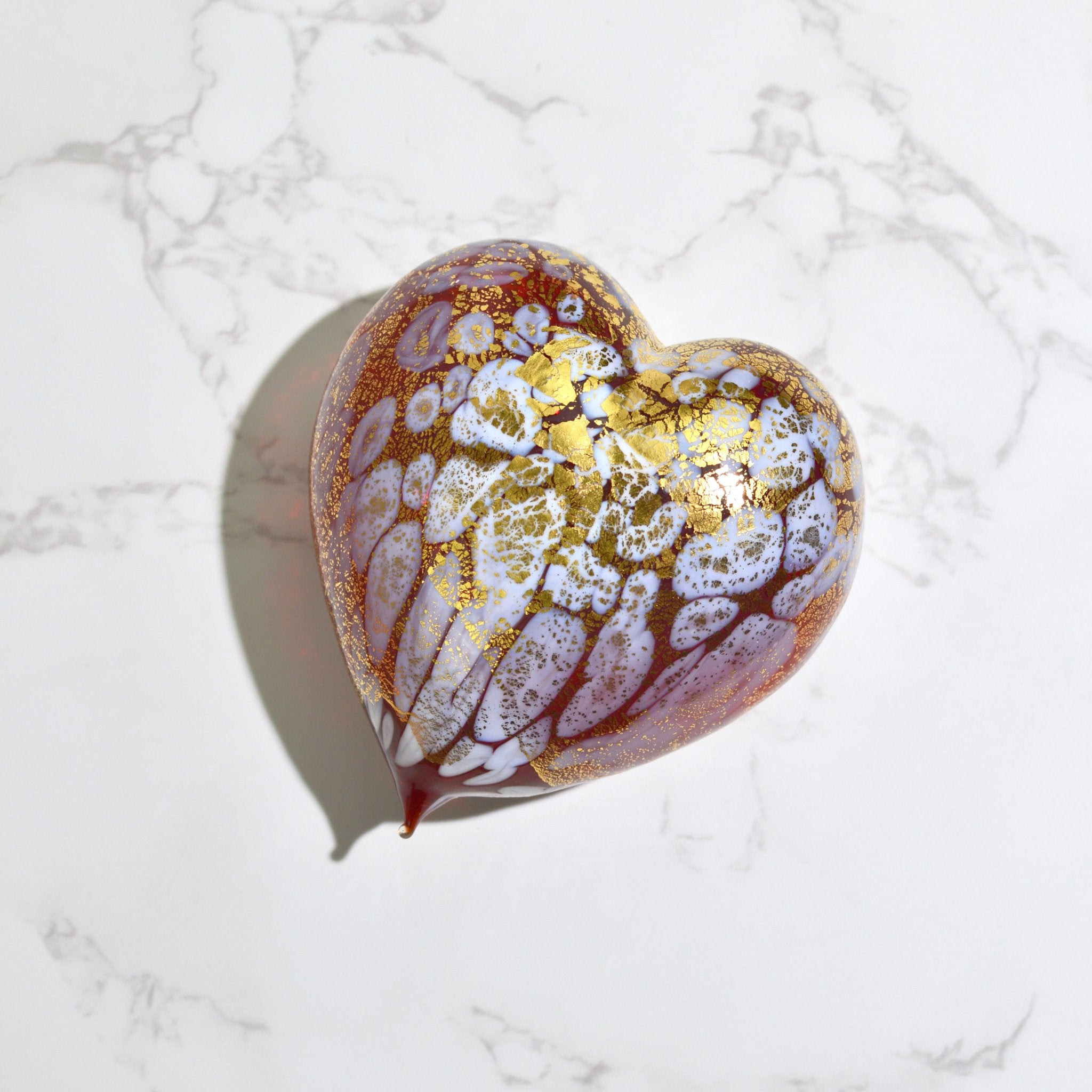 Murano blown glass heart figurine with macchia pattern and 24 kt gold patina, featuring warm amber tones and intricate craftsmanship.