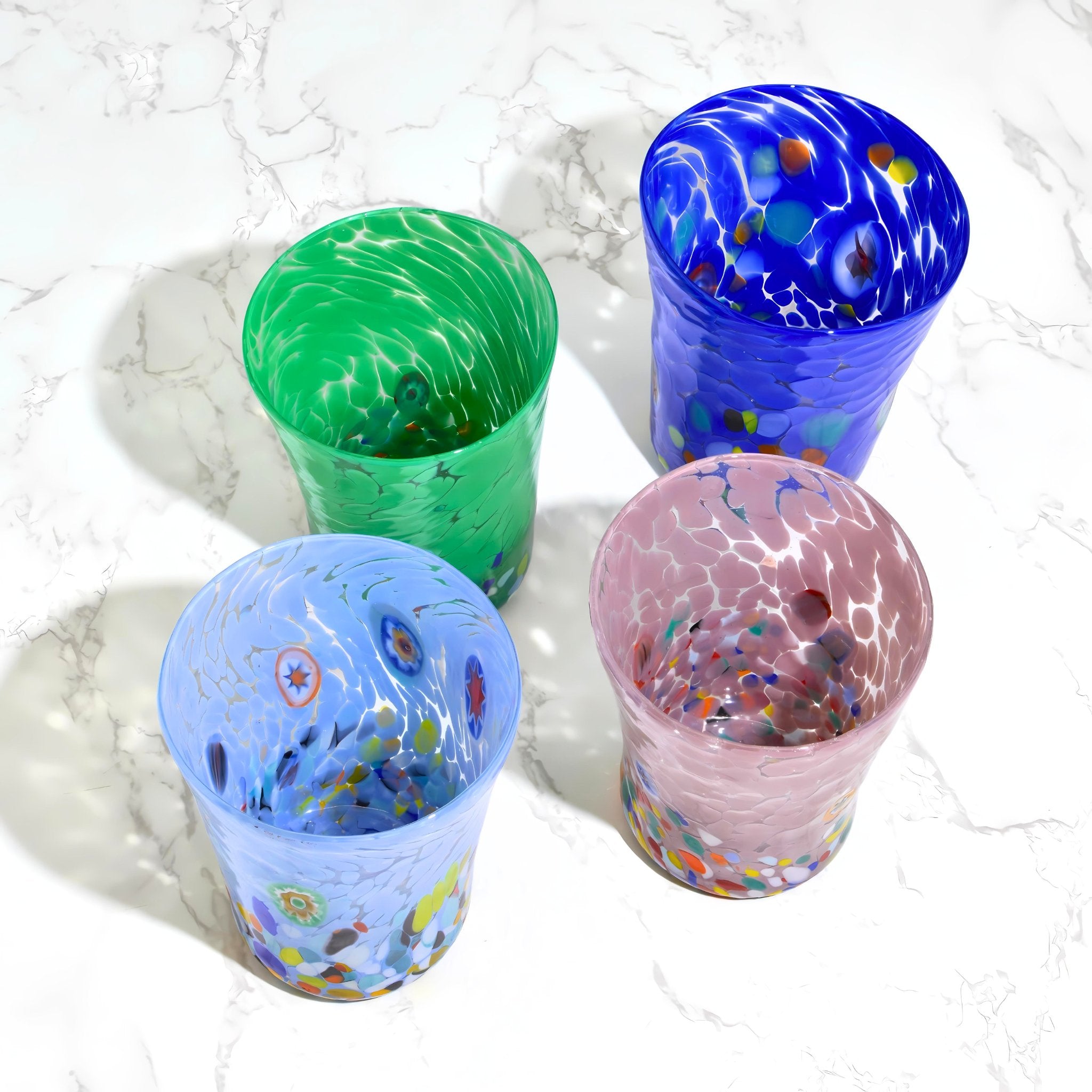Medici Murano glass tumbler set featuring colorful Millefiori patterns in green, light blue, cobalt, and lavender.