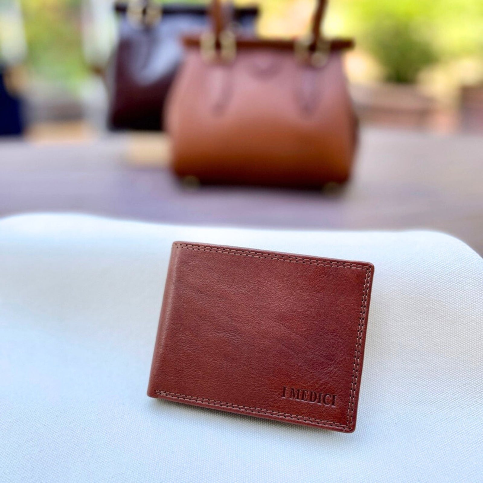 Men's Italian leather bi-fold wallet from MyItalianDecor, in black and brown, showing sleek design and multiple card slots.