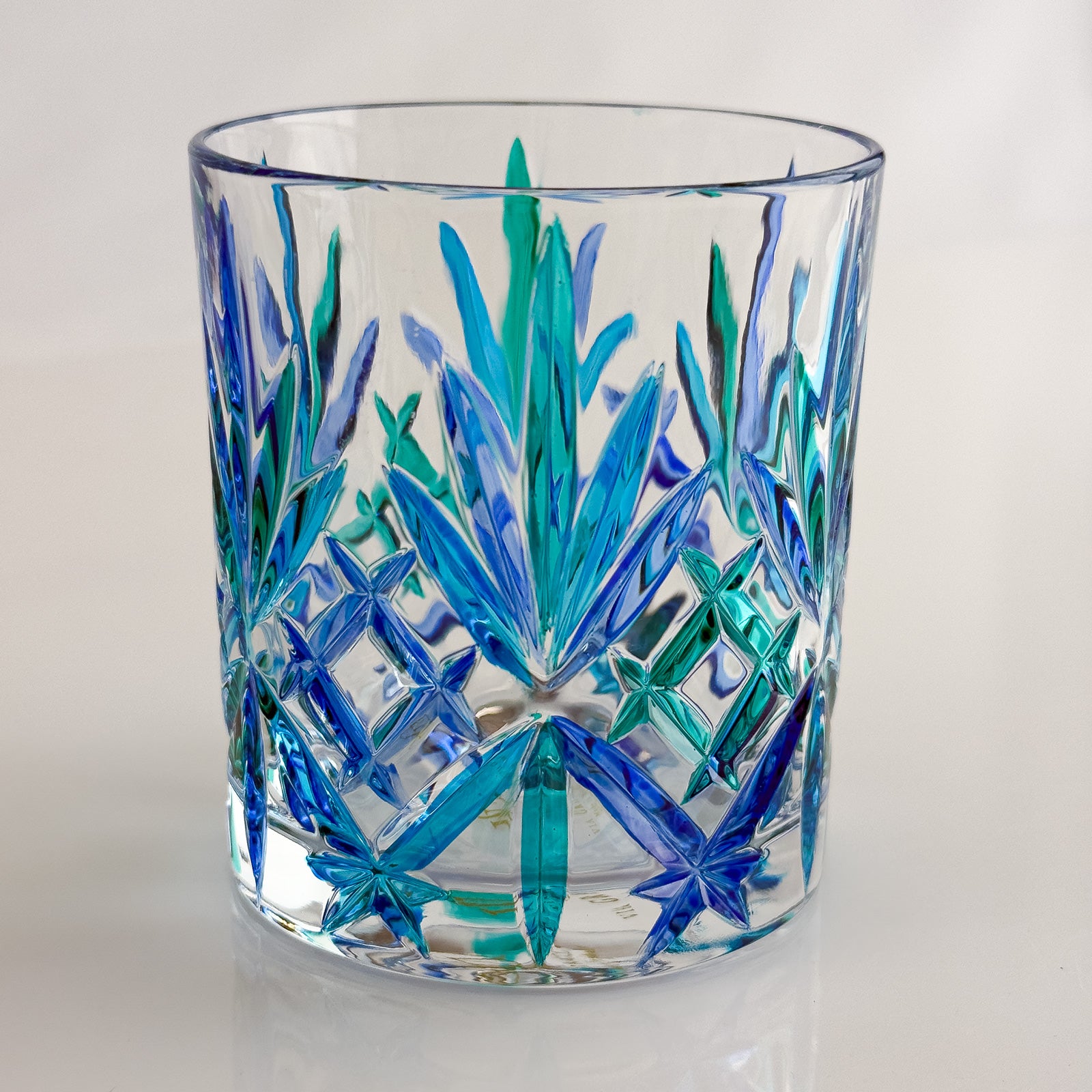 Set of 2 DZ Melodia crystal tumblers in blue and green, featuring elegant, transparent glass for stylish drinking.