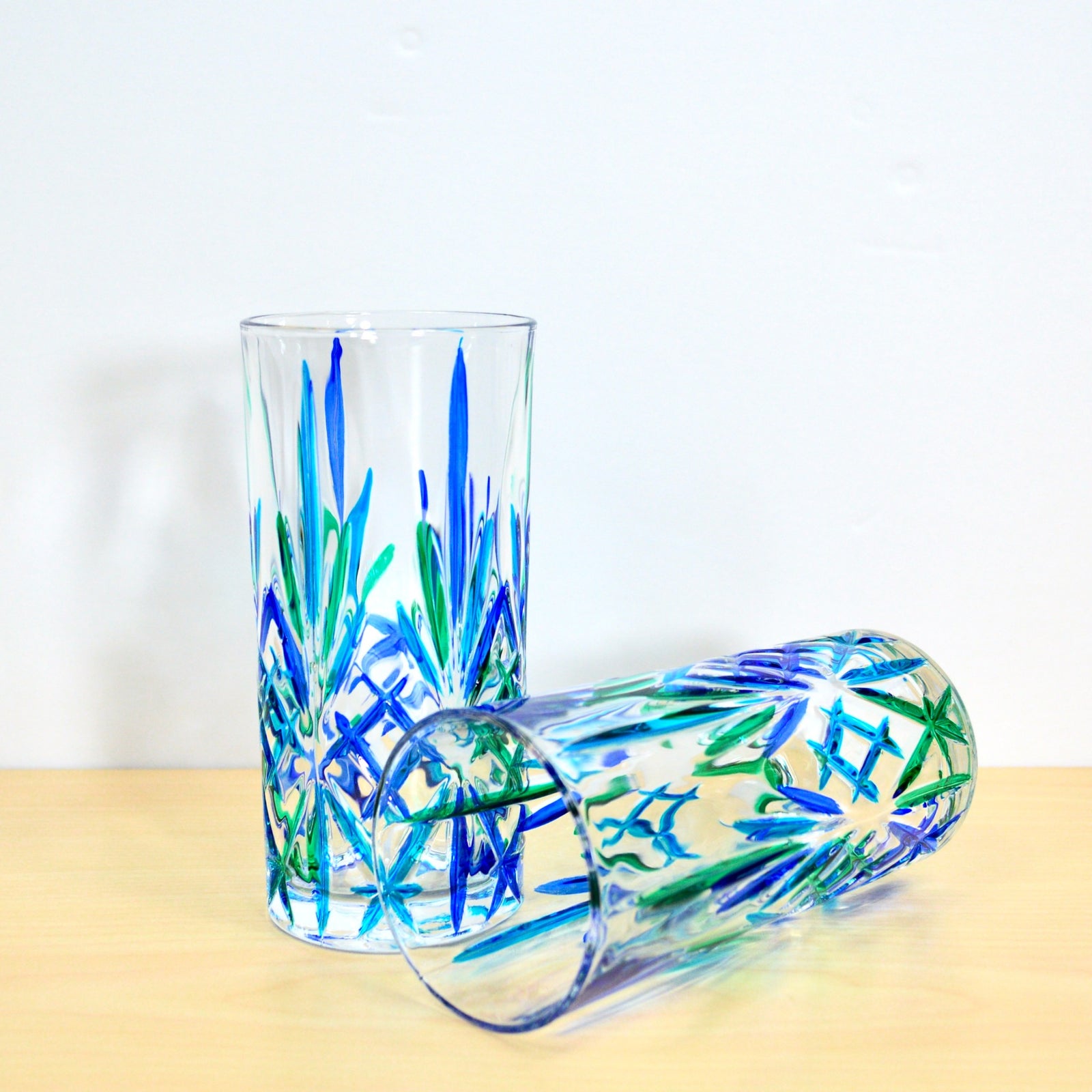 Set of 2 DZ Melodia tall drinking glasses in blue and green, made in Italy, featuring a sleek tumbler design.