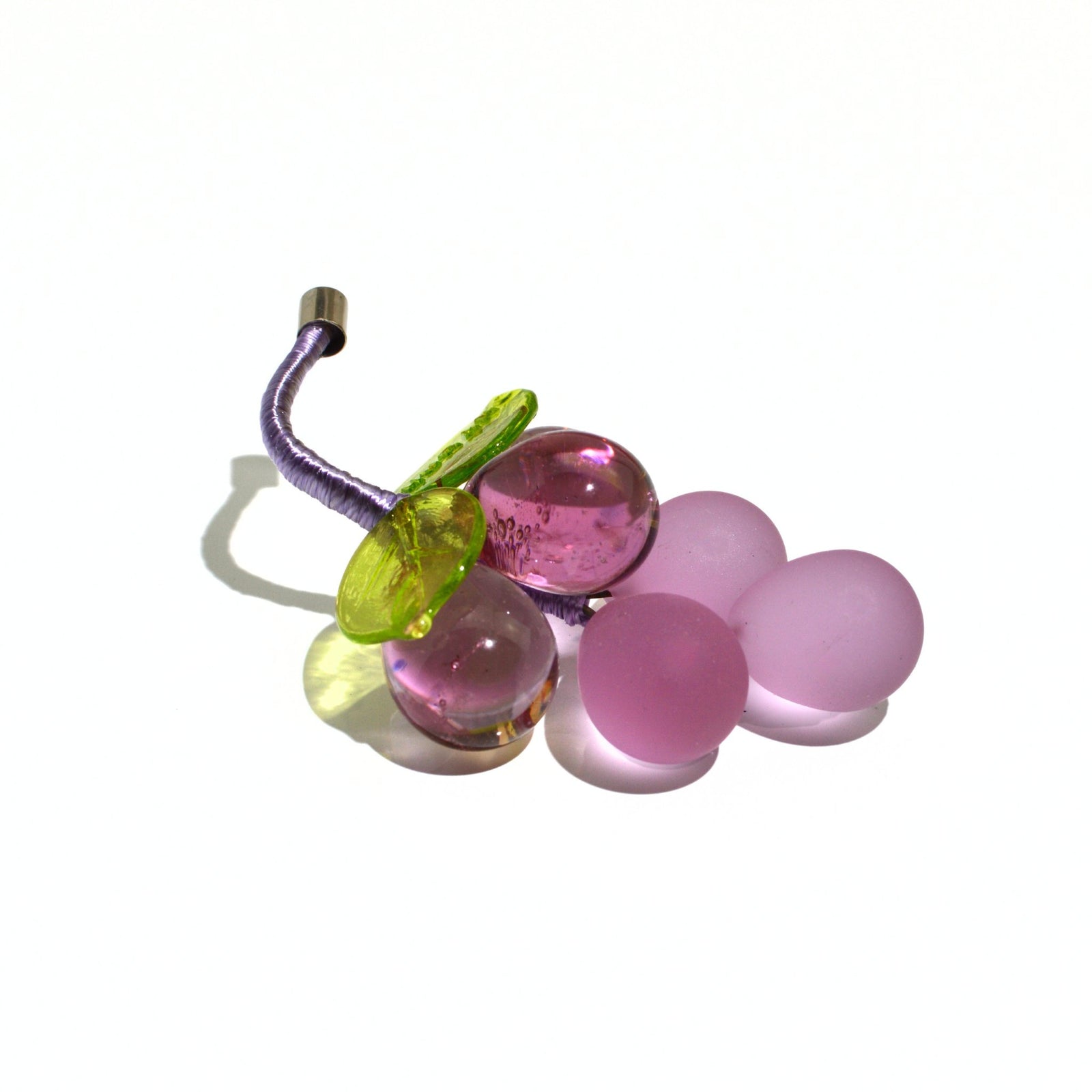 Mini Murano glass grape cluster in multiple colors, made in Italy, artificial floral decoration displayed in a bowl.