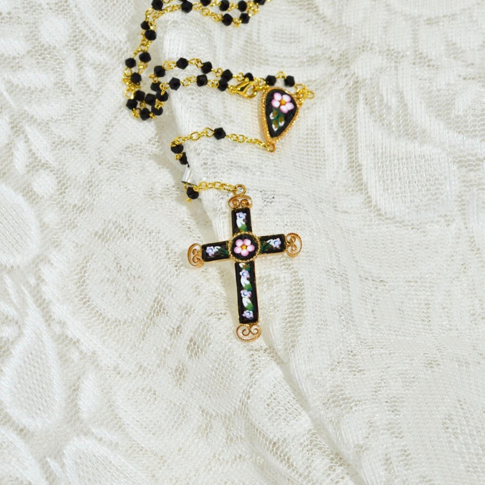 Close-up of a handcrafted Florentine mosaic rosary necklace with intricate mosaic beads, made in Italy.