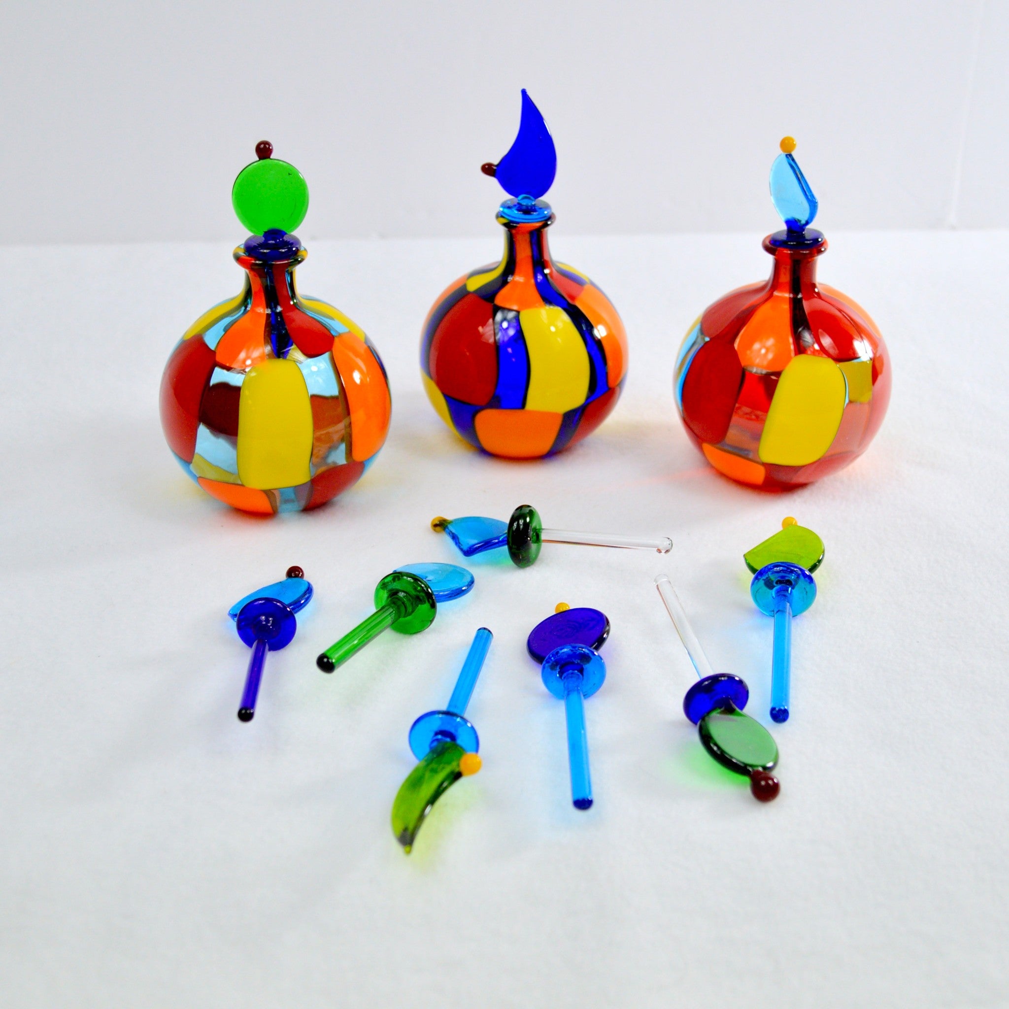 Small round Pazzia Murano glass perfume bottle with handblown art, featuring colorful decorative glass and elegant design.