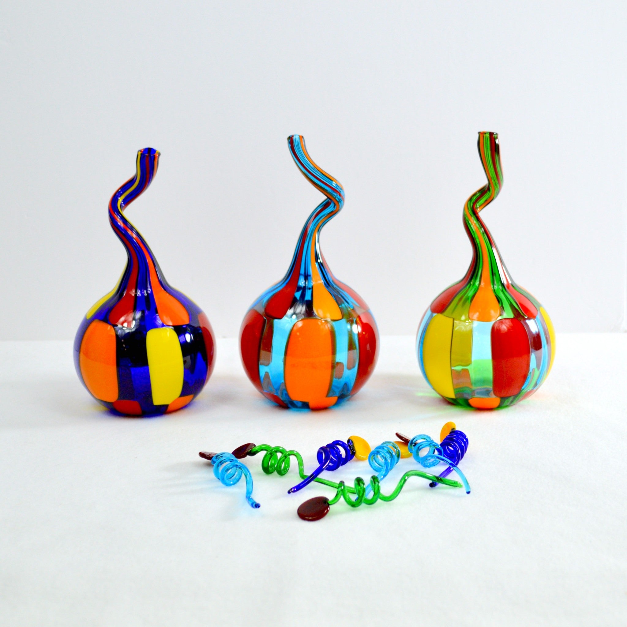 Handblown Murano glass perfume bottle by Pazzia with twist-top, decorative art piece showcasing vibrant colors and intricate craftsmanship.