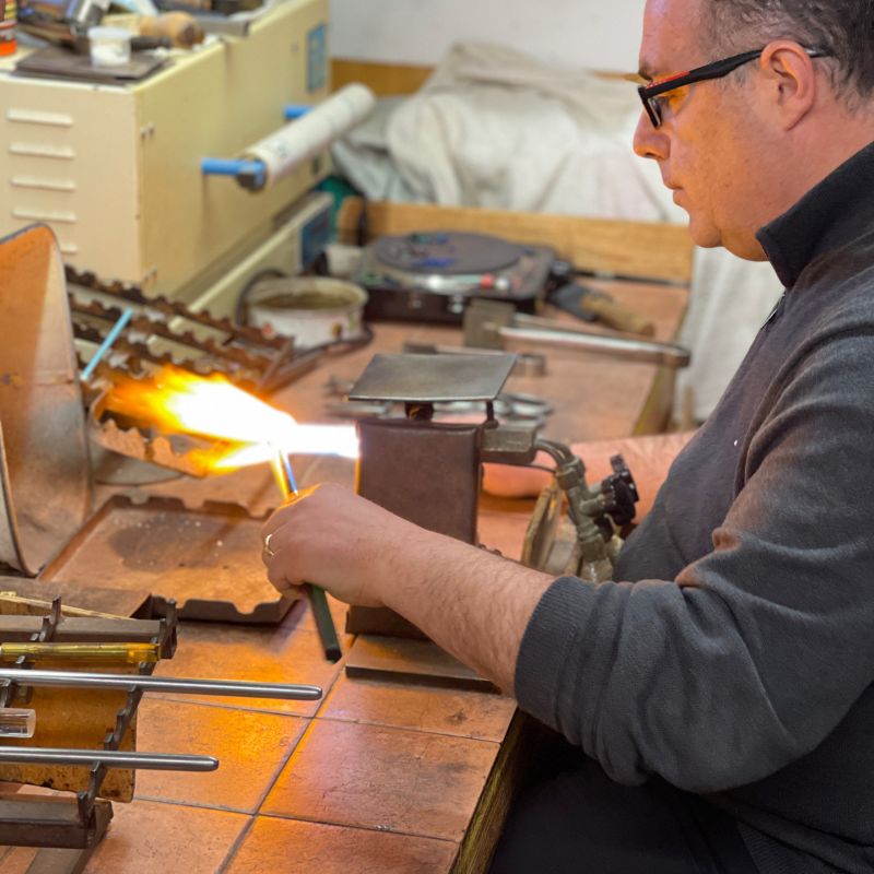Glass artisan at furnace in Murano, Italy