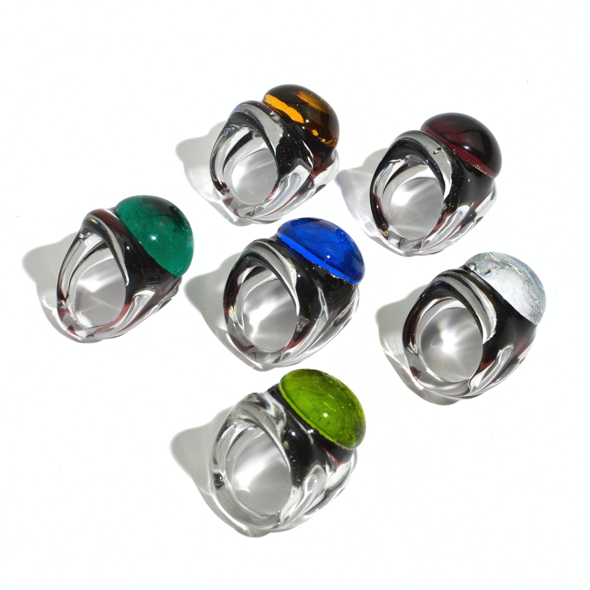 Murano glass Occhio statement rings in various colors, designed by MyItalianDecor, showcasing vibrant glass craftsmanship from Italy.