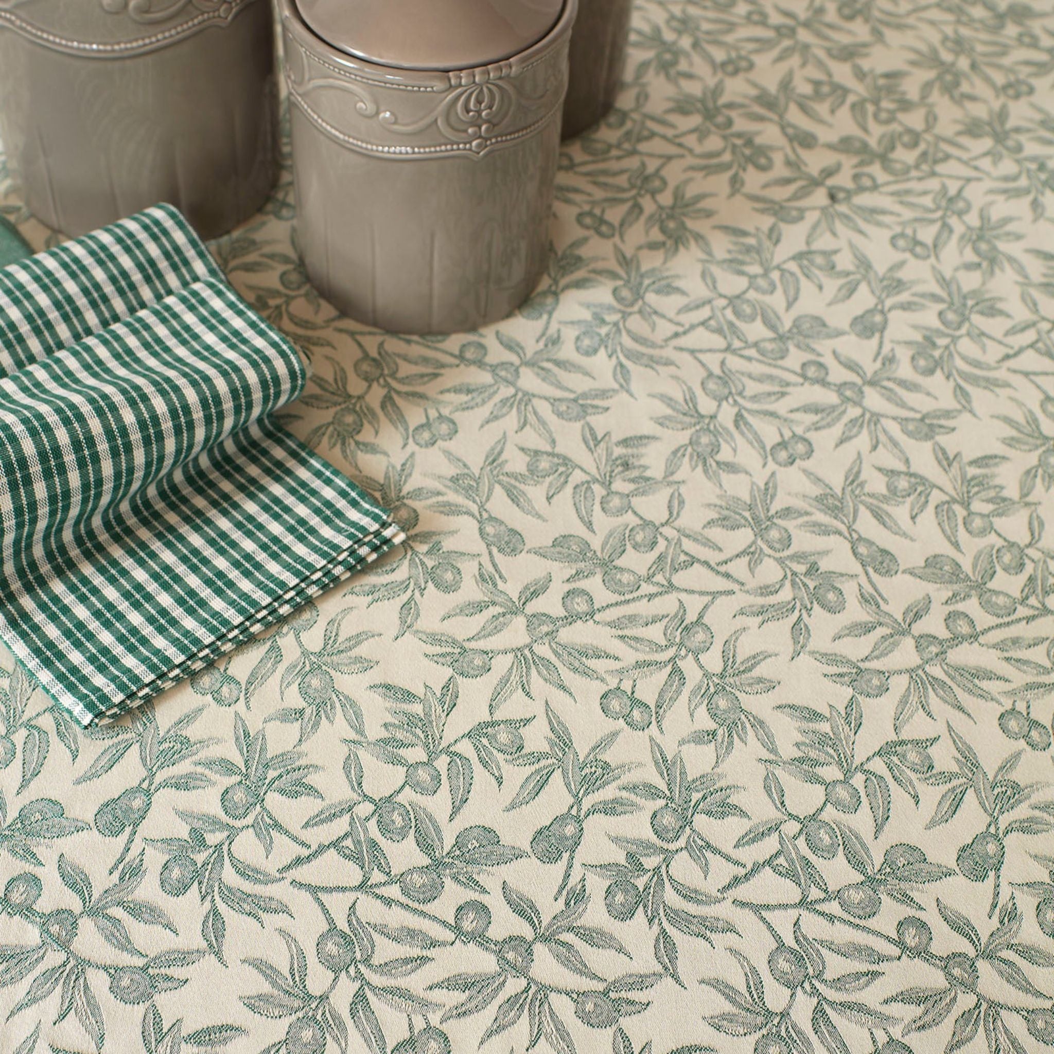 Oliva green Busatti Oliva kitchen towel from My Italian Decor, made in Italy, shown with vibrant, woven linen fabric.