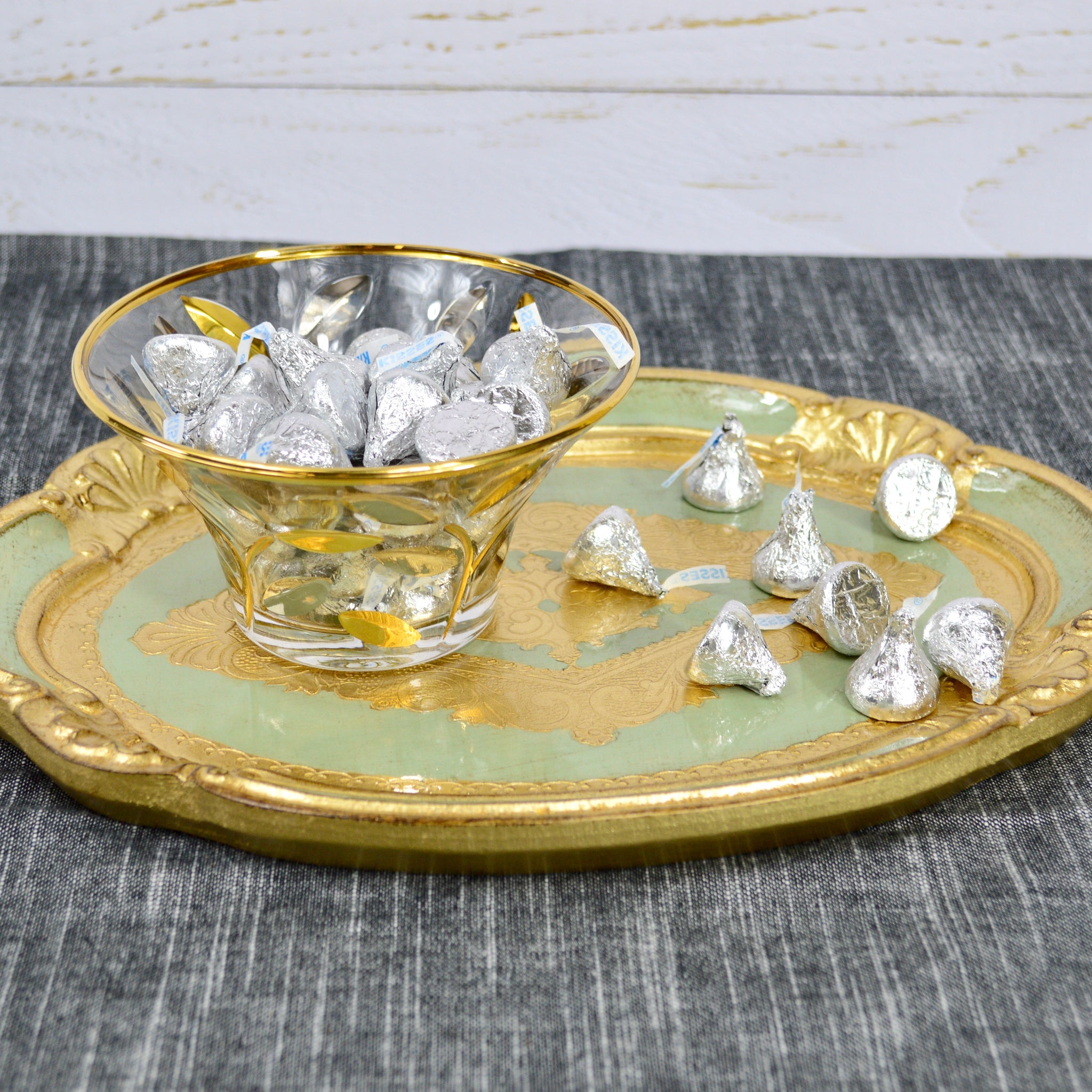 Decorative Florentine carved wood oval tray in sage green and gold, featuring intricate designs in multiple sizes.