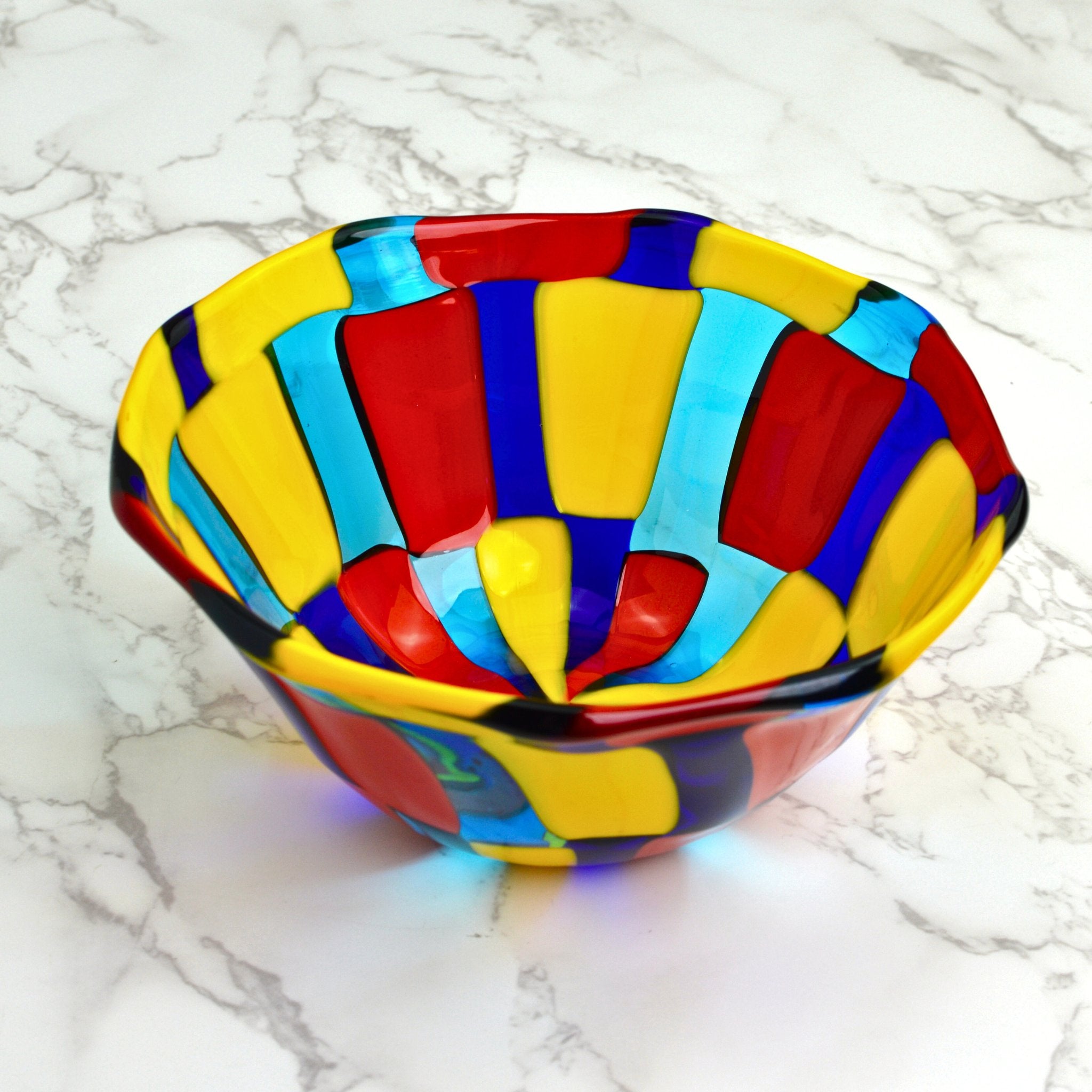 Bright colored Murano glass bowl in yellows, reds, blues and turquoise colors.