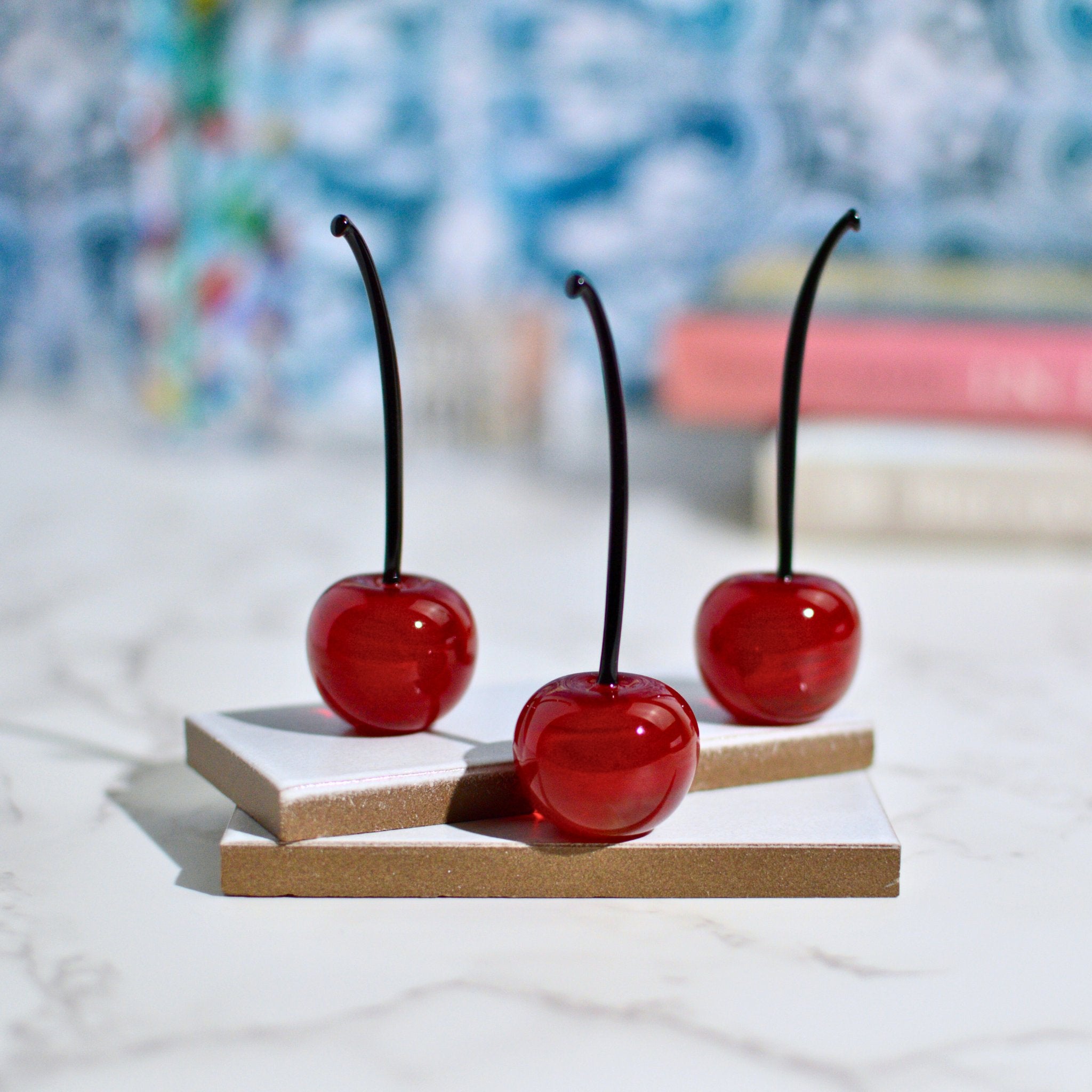 Lifelike red Murano glass cherries in a set of 3, made in Italy, arranged as artificial decorative flora.