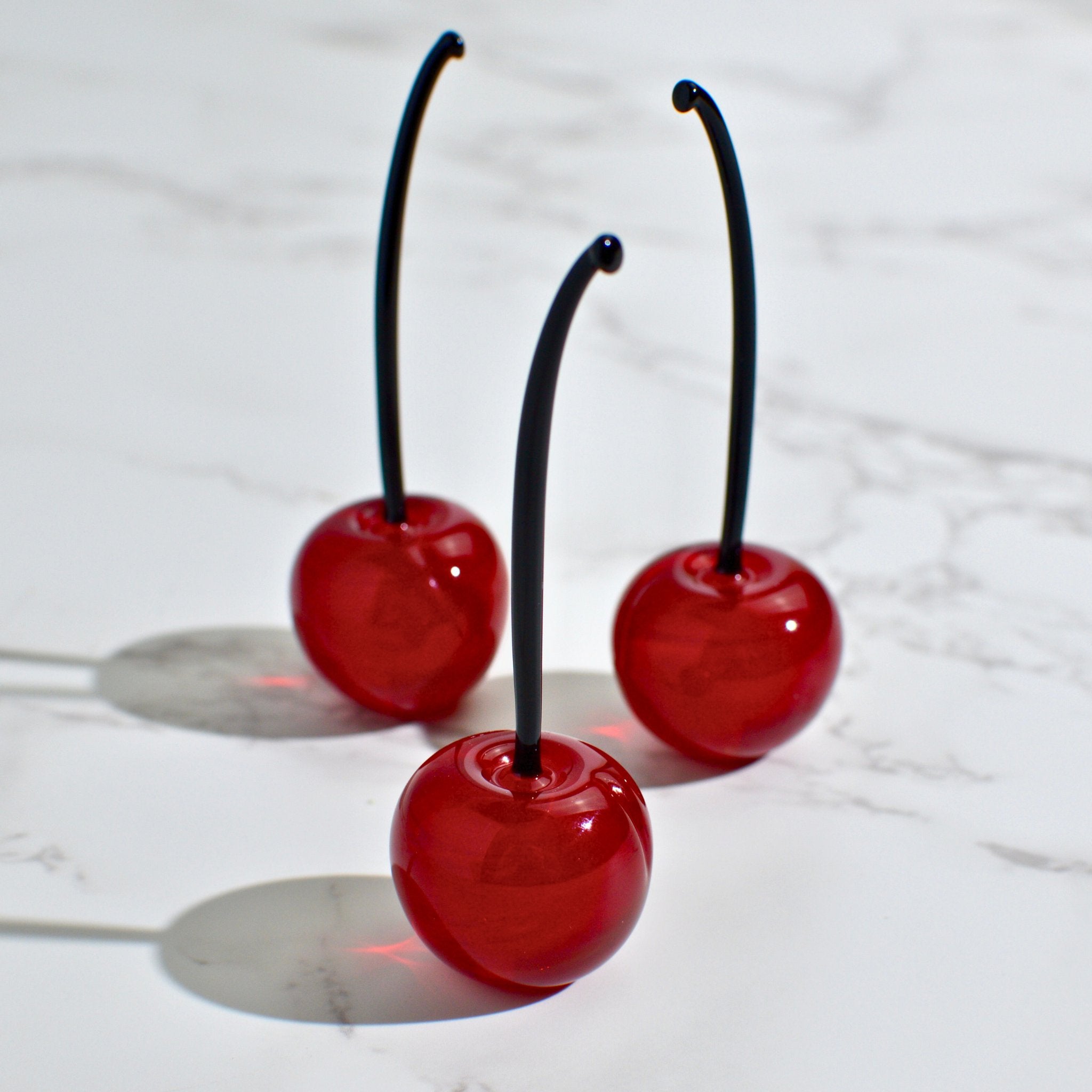 Set of three lifelike Murano Glass cherries in vibrant red, made in Italy, perfect for artificial floral arrangements.