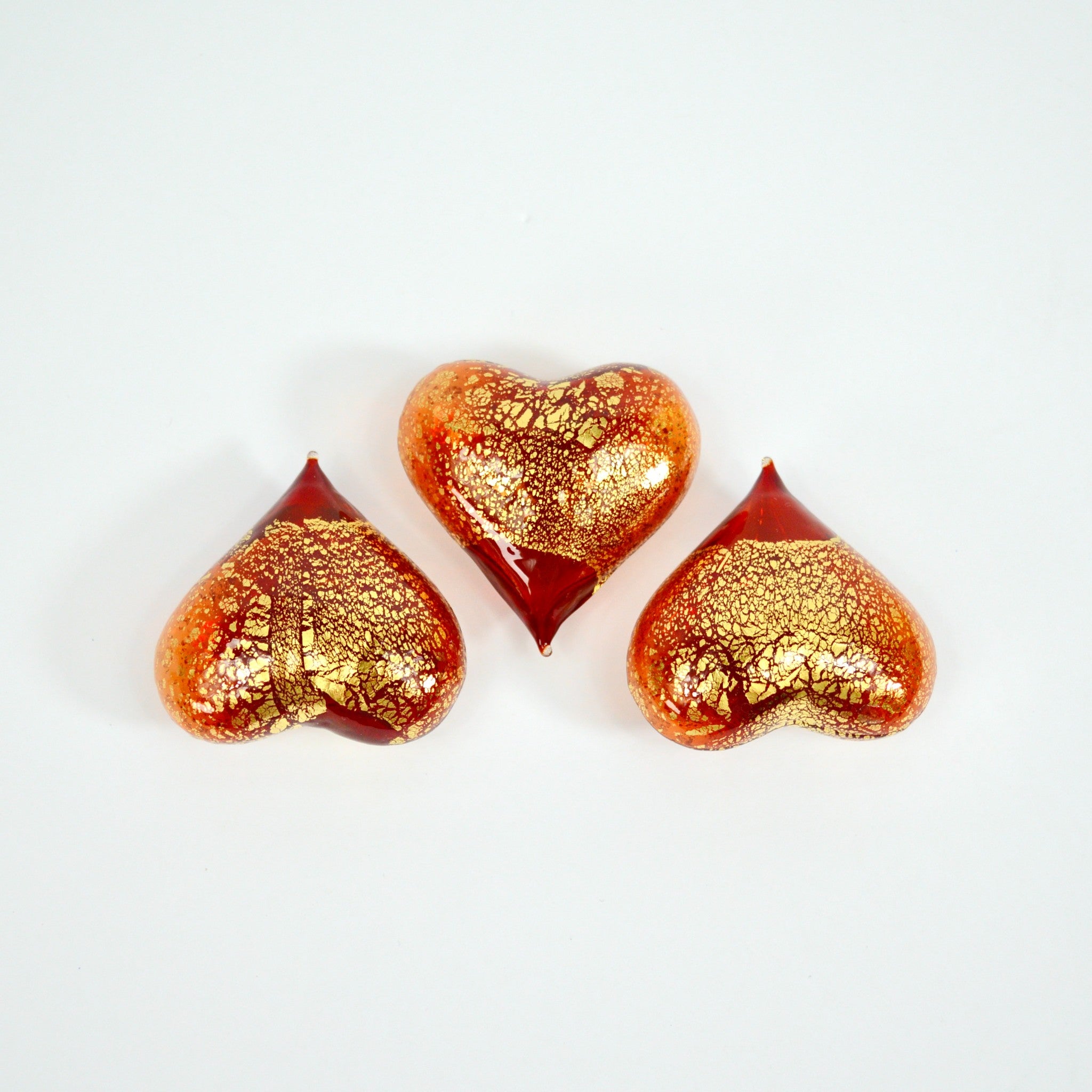 Set of three small Murano glass heart figurines in red and transparent colors, handcrafted in Italy by MyItalianDecor.