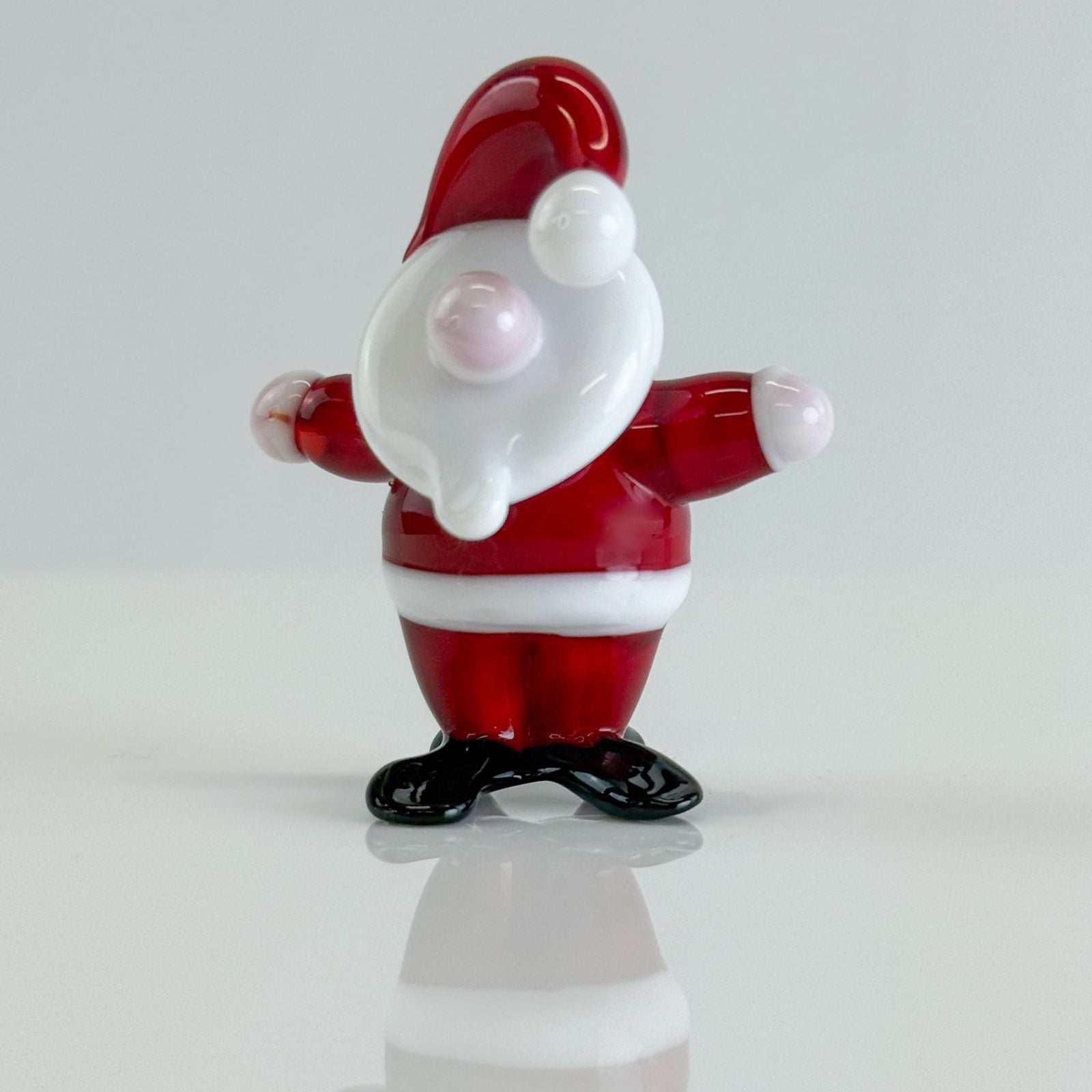 Three colorful Murano glass Santa figurines from Italy, detailed holiday decorations for seasonal decor.