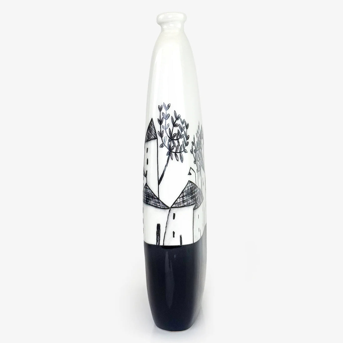 Side view of a tall, ceramic vase with a glossy white finish, featuring a hand-painted black and white illustration of houses and trees on the front, set against a plain light gray background.