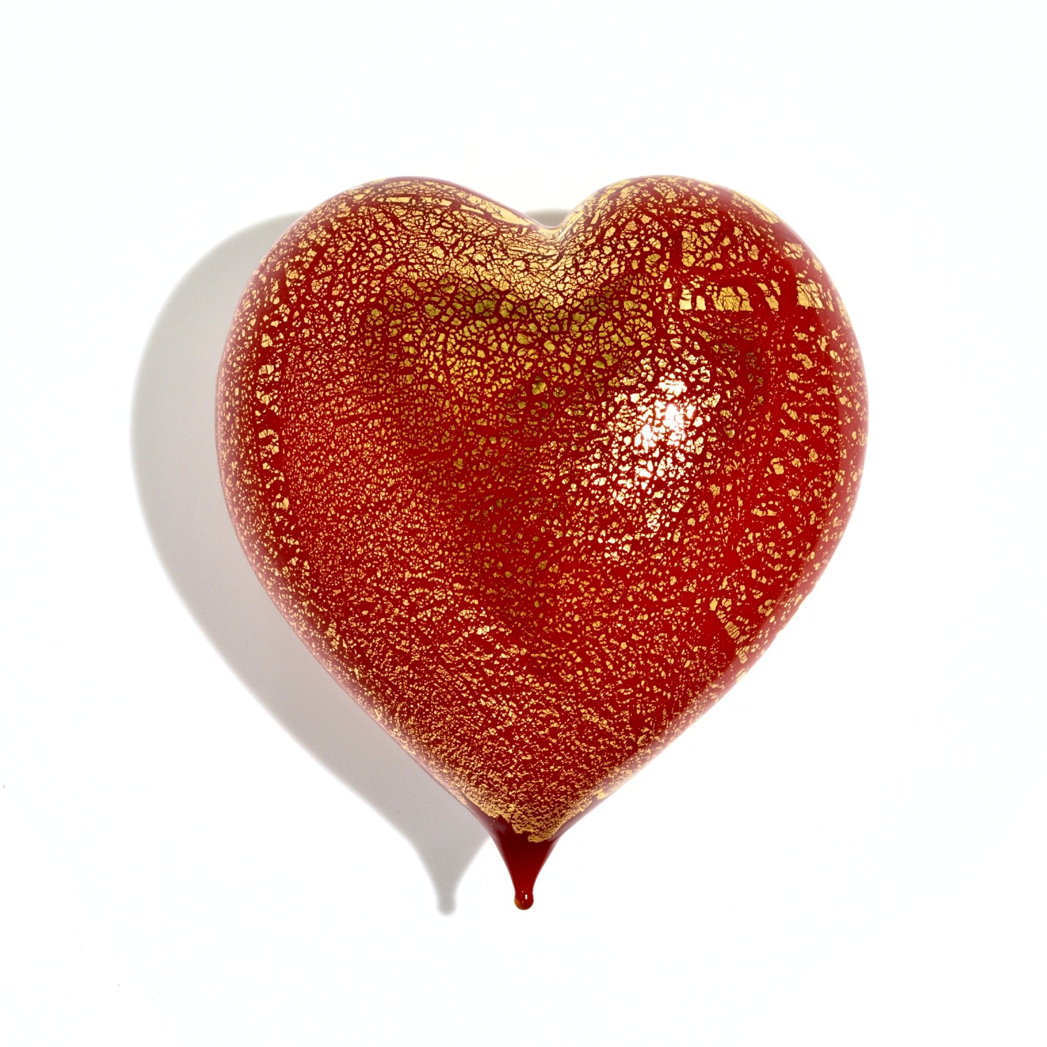 Red Murano glass heart figurine with 24-karat gold accents, handmade in Italy, showcasing vibrant color and elegant craftsmanship.