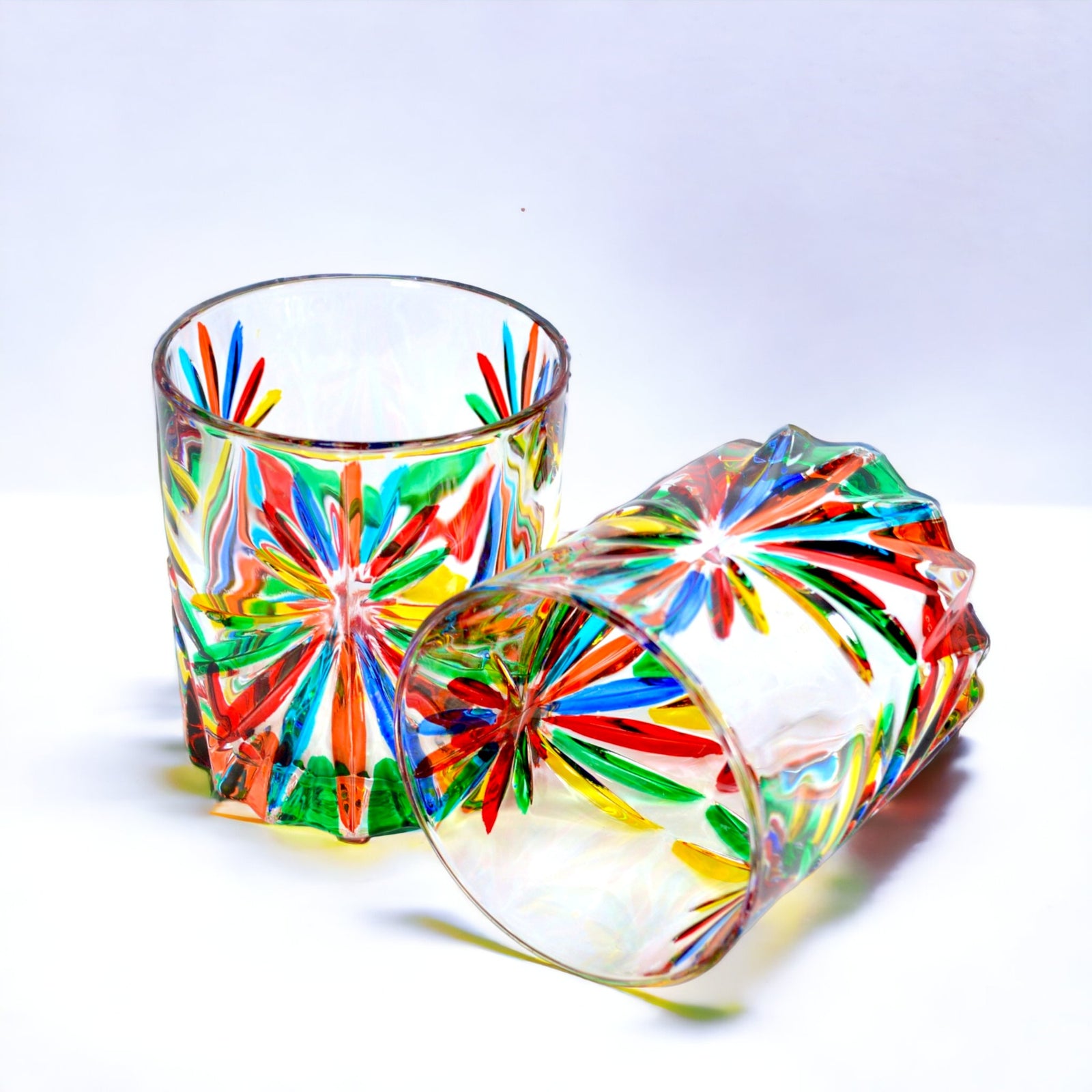Set of 2 DZ Starburst short drink glasses, hand-painted Italian crystal tumblers with a reflective starburst design.