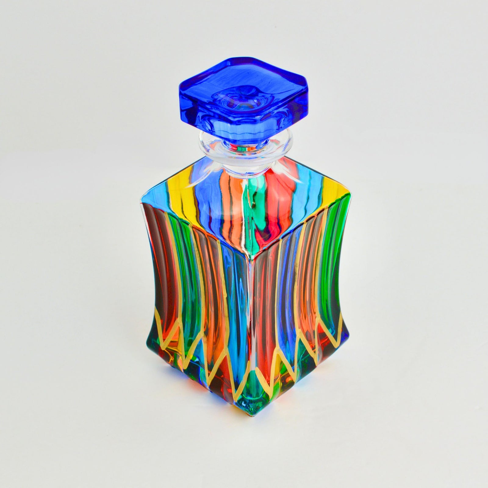 Overhead view of a hand-painted Italian crystal decanter with intricate designs, showcasing elegant craftsmanship and clarity.