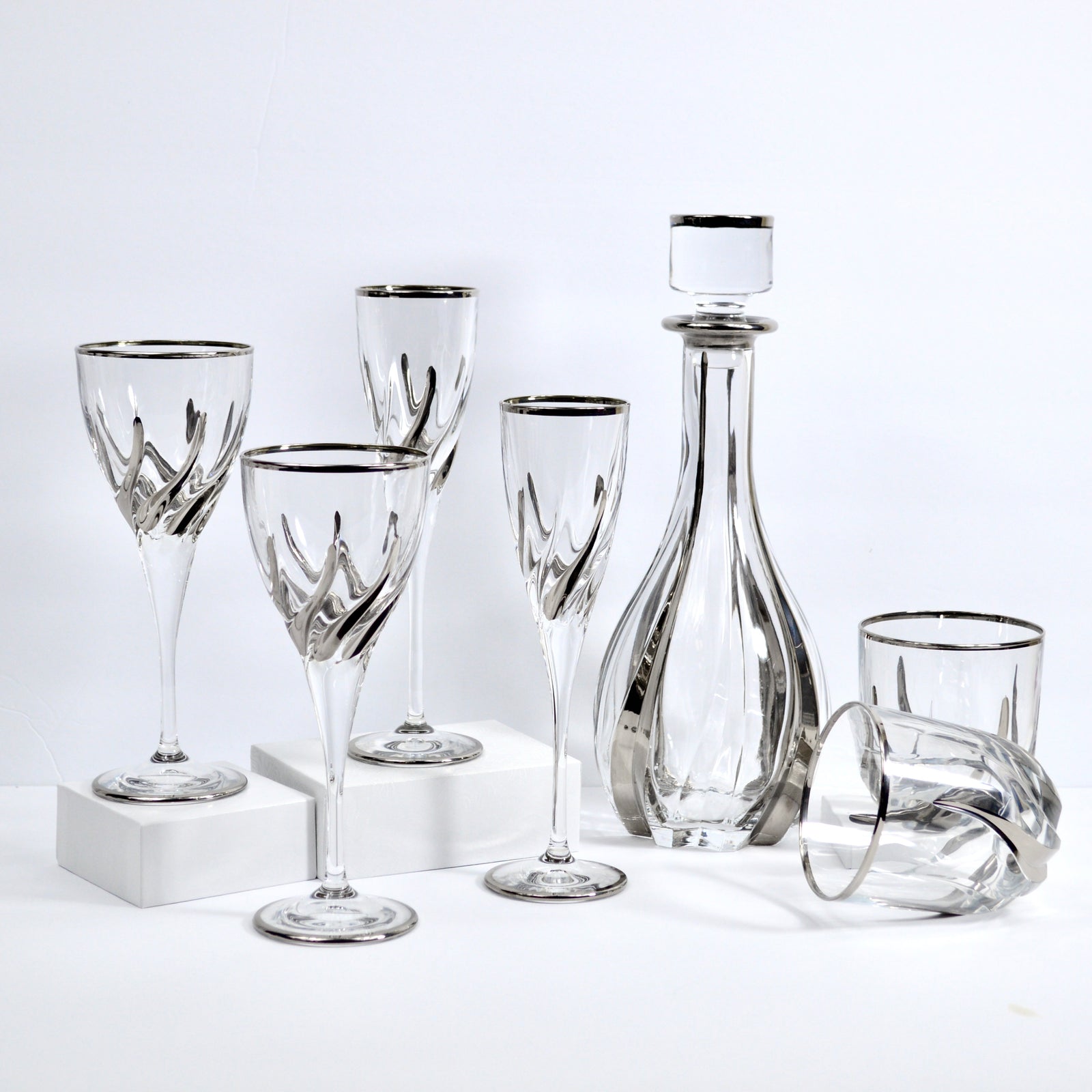 Set of two DZ Trix wine glasses with platinum accents, made in Italy, featuring elegant, clear glass design for vino presentation.