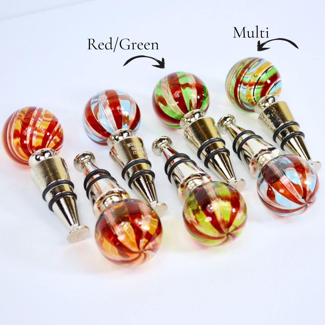 Set of assorted Murano glass wine stoppers from Italy with colorful, handcrafted designs for bottle sealing and preservation.