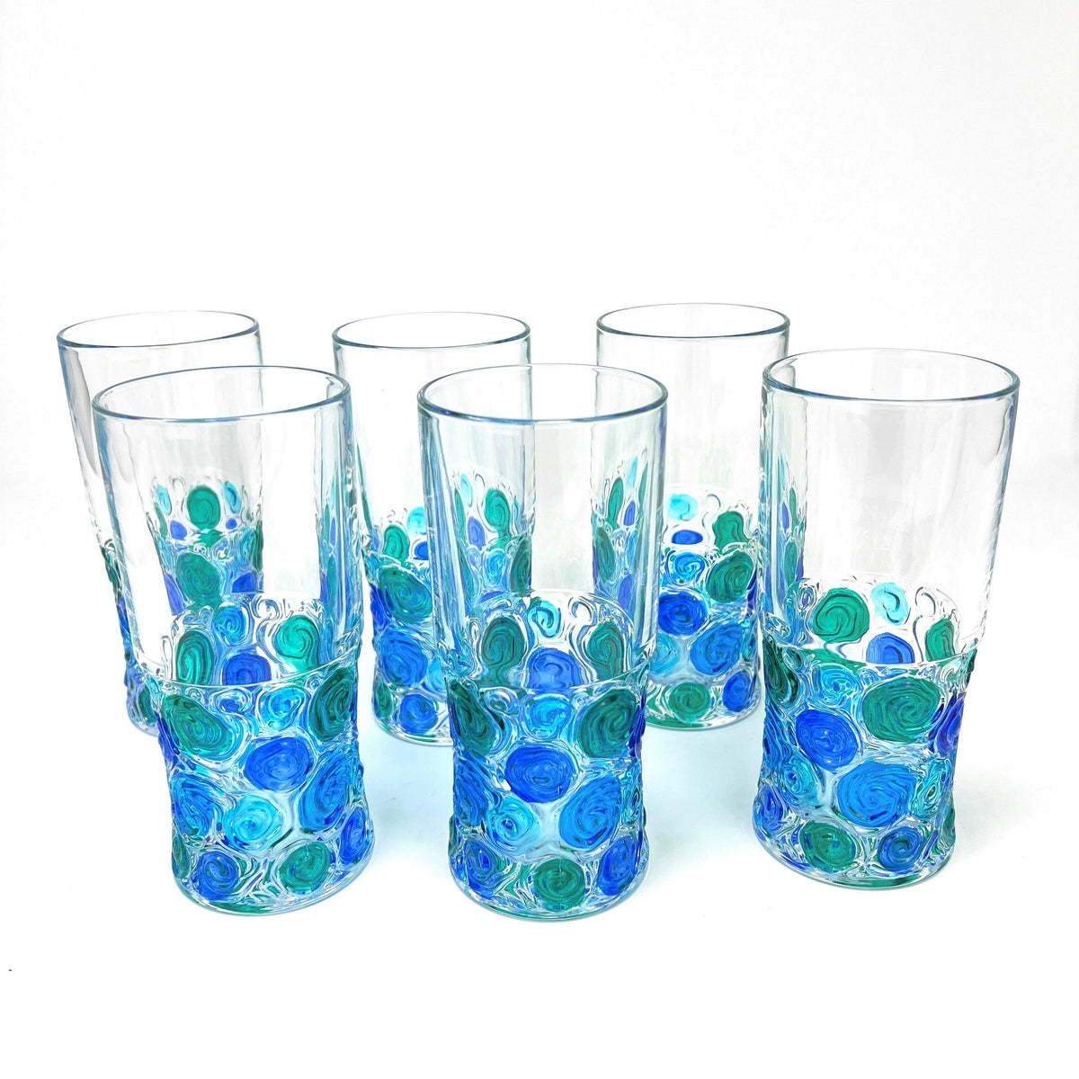 Six Italian Crystal tall drinking glasses with bright blue, green, and turquoise swirls of color on the bottom half.