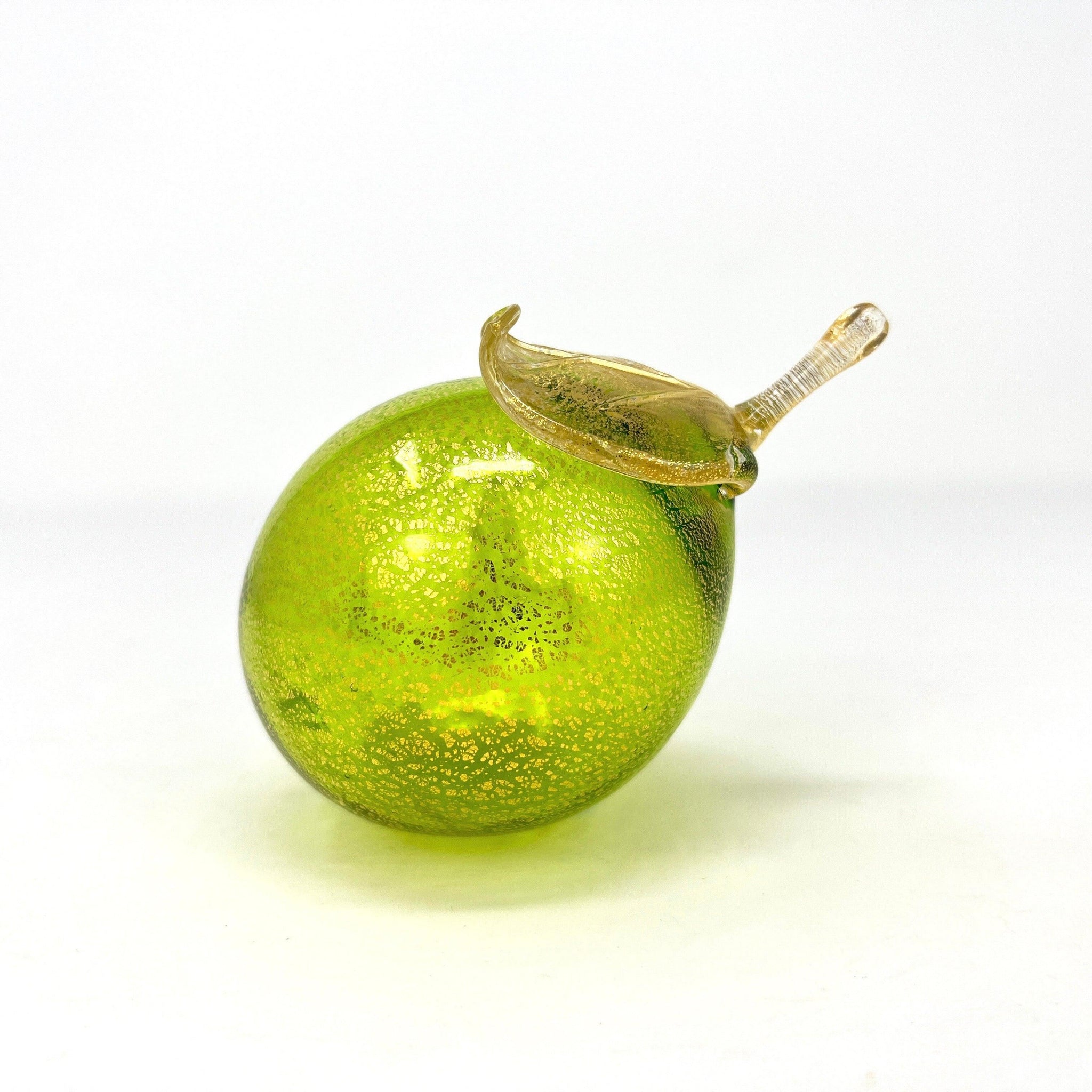 Life-size Murano glass limes, blown glass artificial fruit from Italy, vibrant green and yellow decorative fruit for home decor.