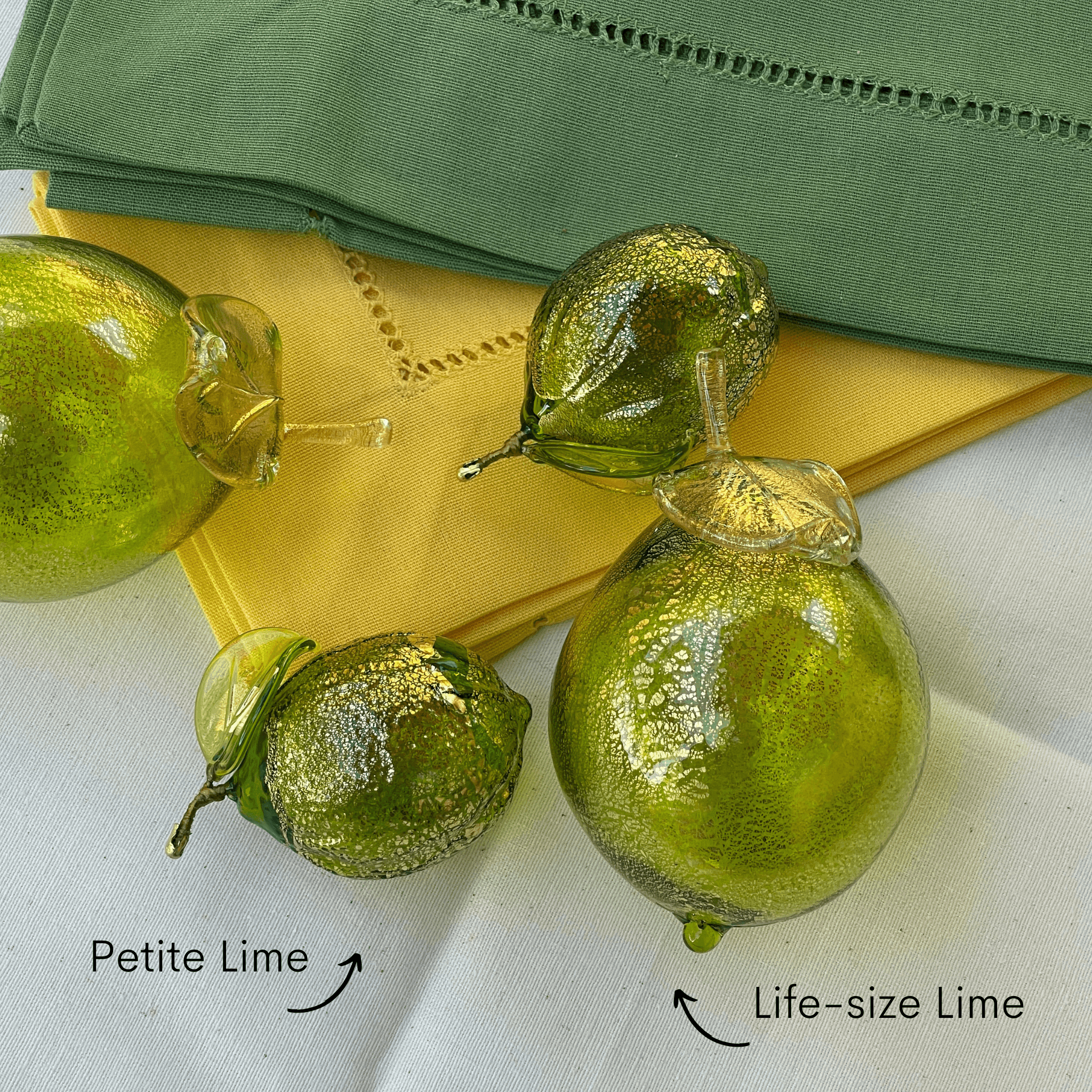 Life-size Murano glass limes, blown Italian artificial fruit, showcasing vibrant green citrus replicas with detailed glass craftsmanship.