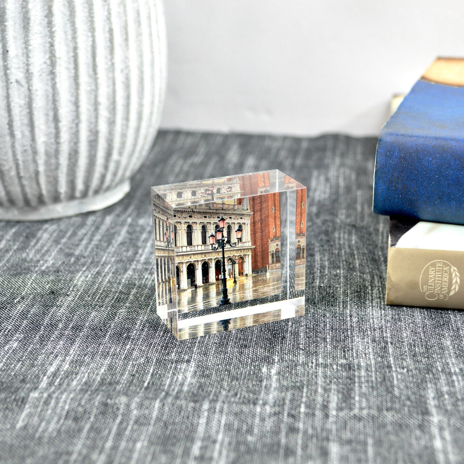 Acrylic photo cube displaying authentic Italian-themed pictures, featuring clear, glossy acrylic frame with multiple photo slots.
