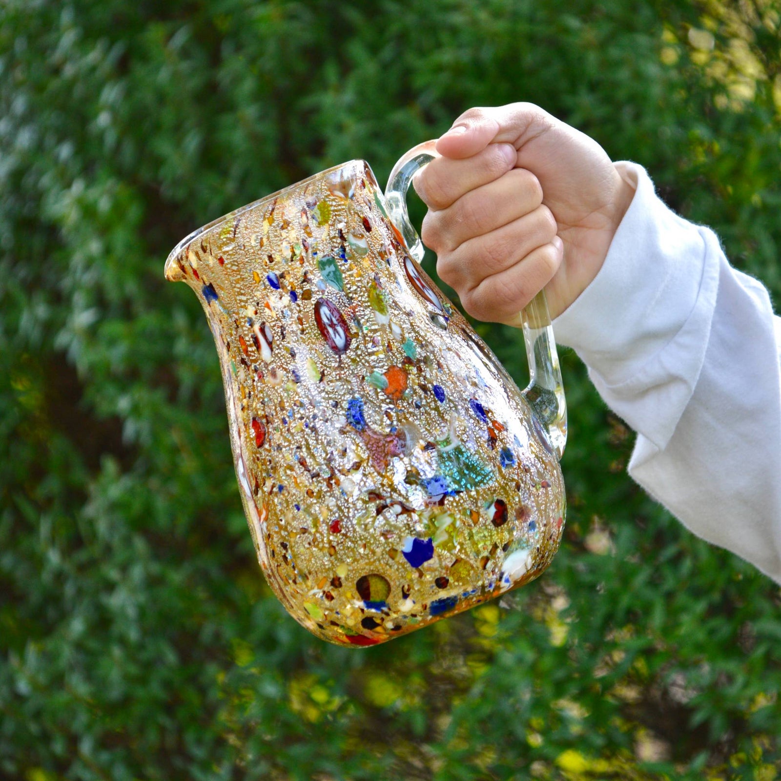 Amber Murano glass Alta Round Drink Pitcher by DZ featuring colorful millefiori design for serving beverages.