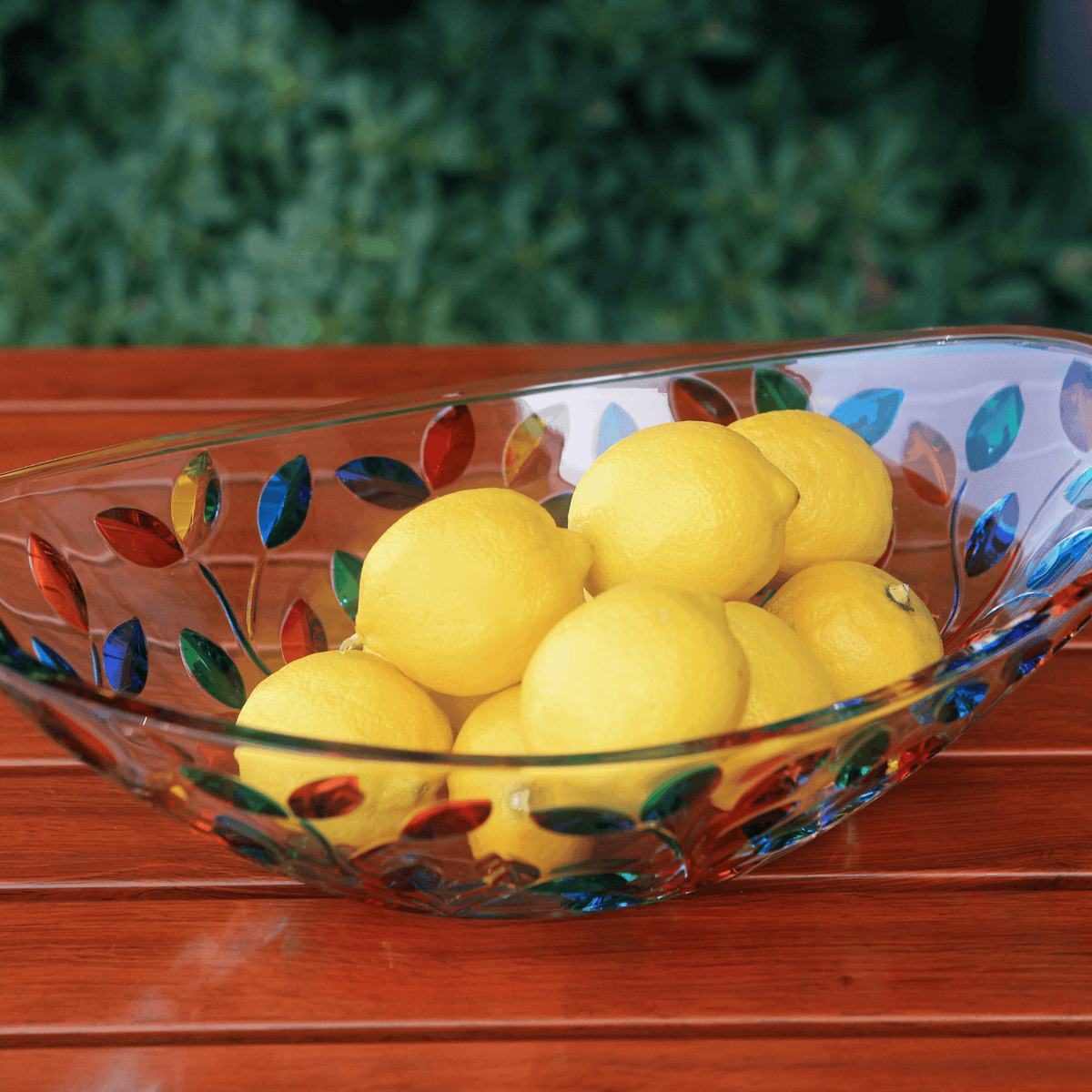 floral pattern in bright colors on an oval shaped italian crystal bowl filled with lemons