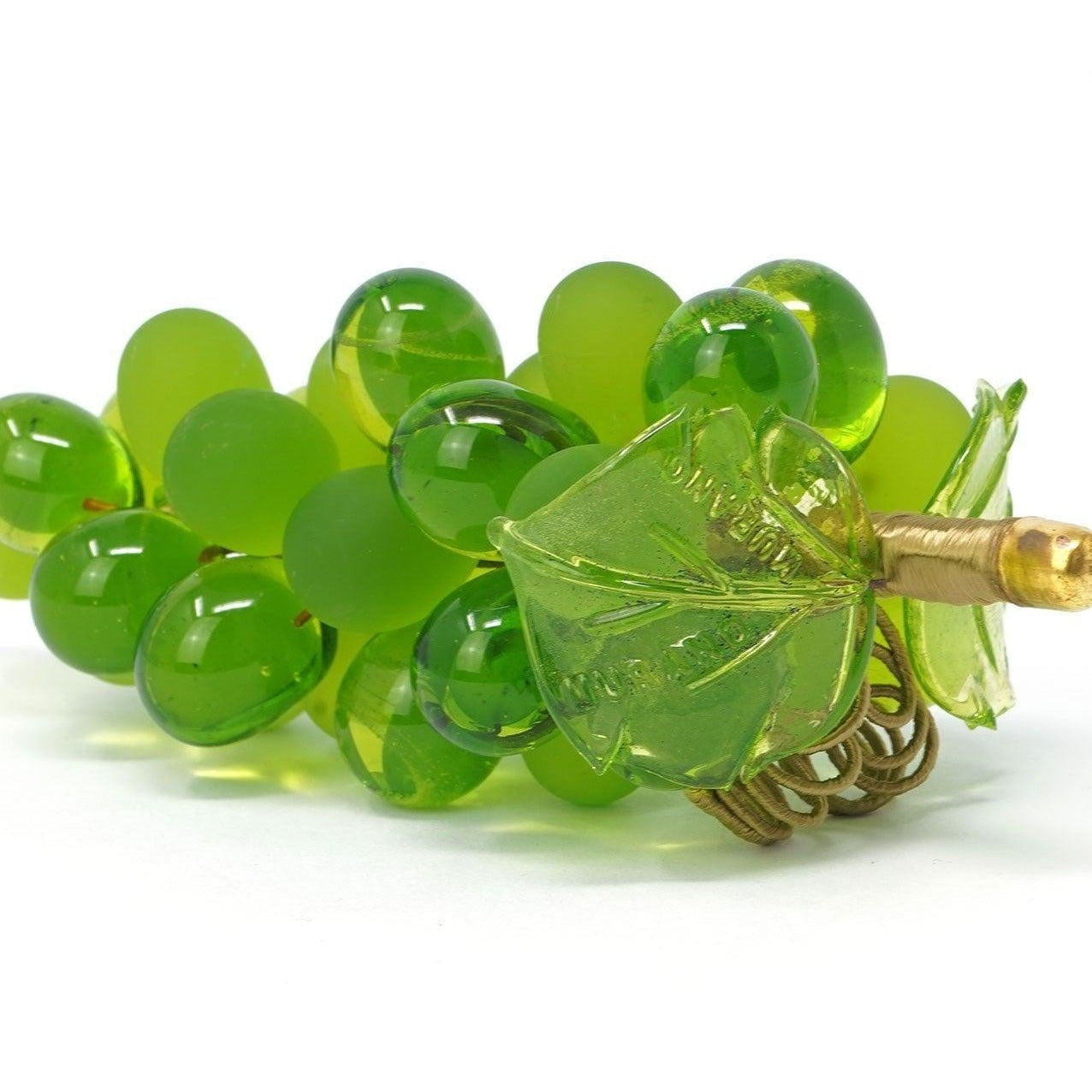 Large light-green Murano glass grape cluster, artificial flora made in Italy, showcasing detailed craftsmanship and vibrant color.