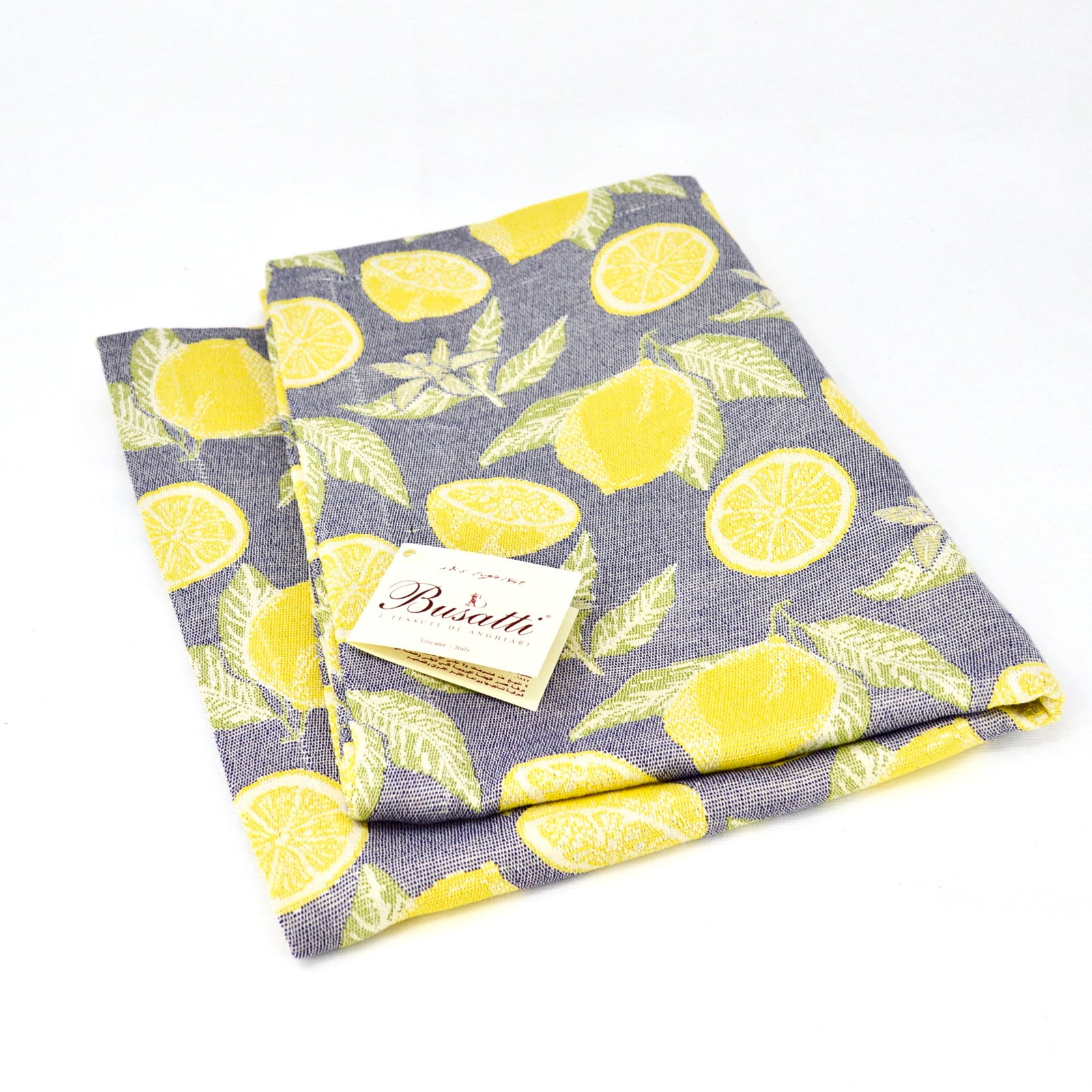 Busatti Lemon table runner made in Italy, featuring bright lemon patterns on elegant linen for a stylish dining table.