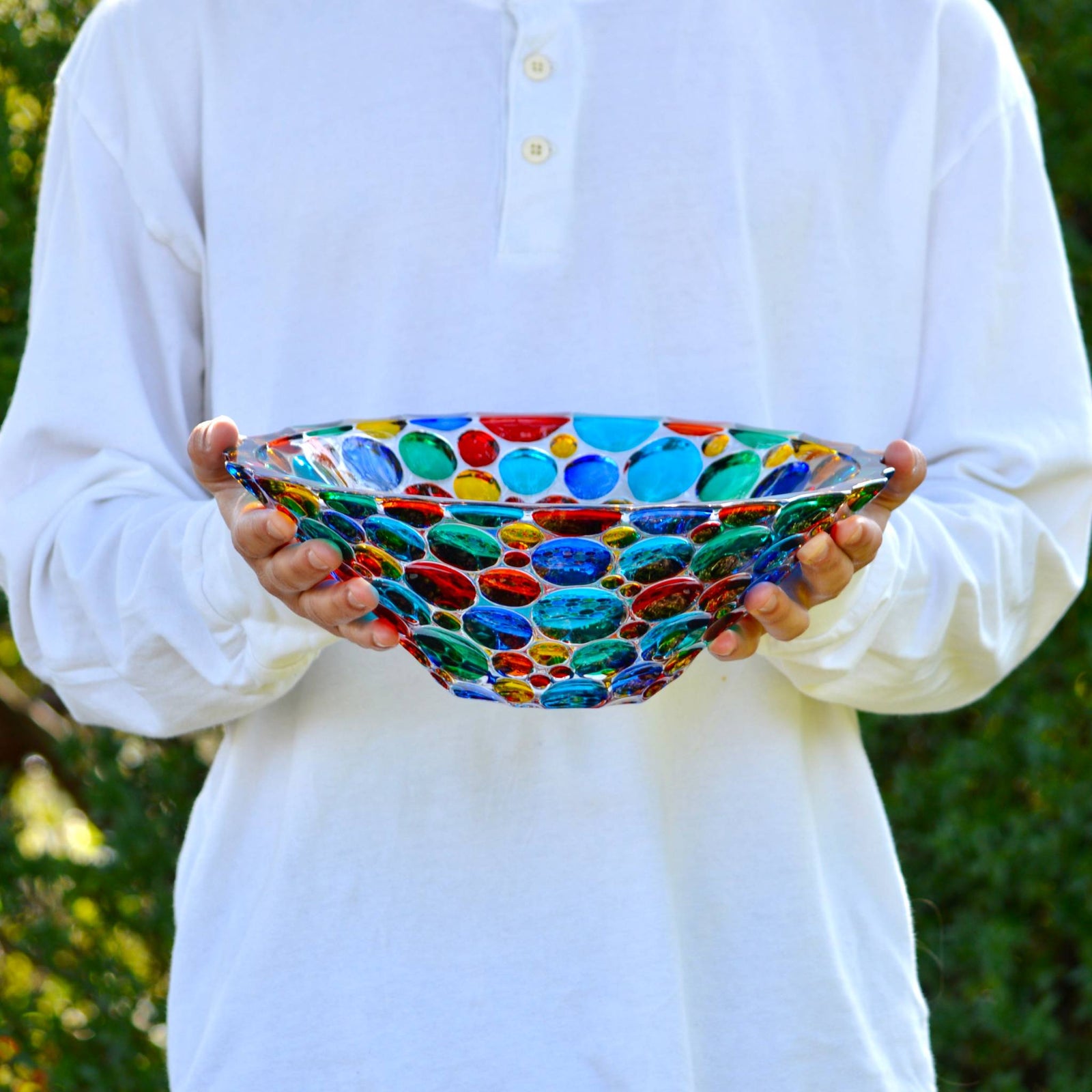 Close-up of DZ Lisboa decorative deep round glass bowl with hand-painted design, filled with fruit, made in Italy.
