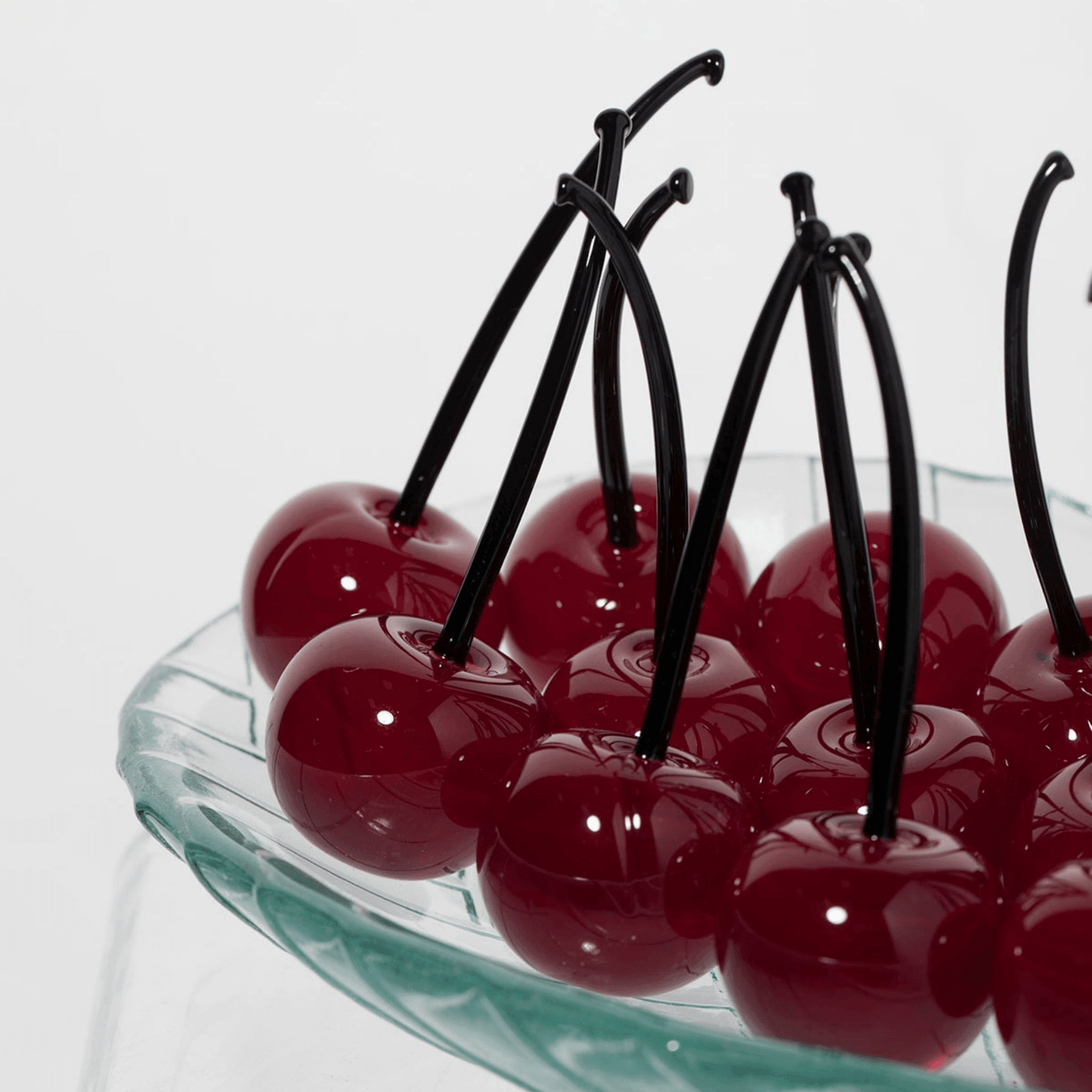 Set of three Murano glass cherries in red and black, lifelike artificial flora made in Italy for decorative displays.