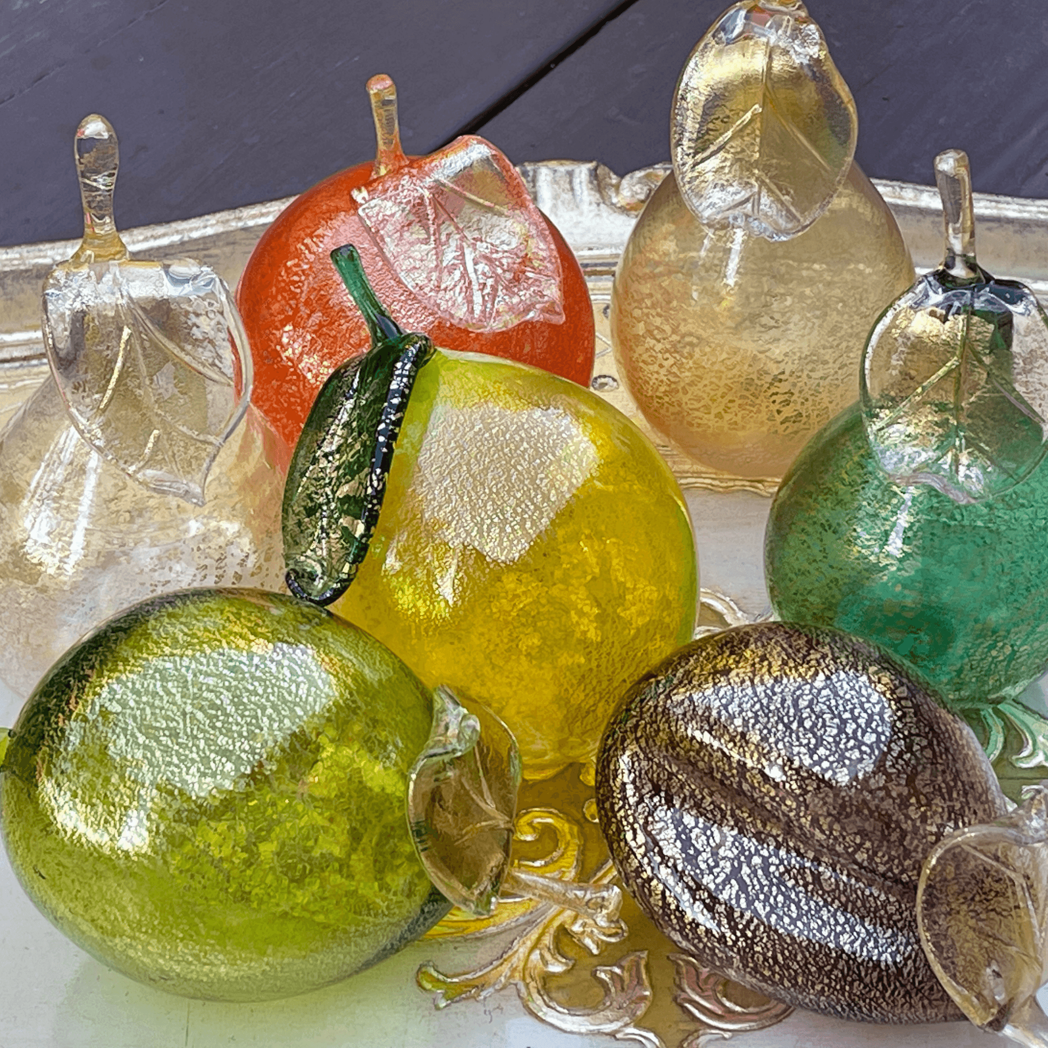 Life-size Murano glass limes, blown Italian fruit art, colorful artificial flora with detailed glass craftsmanship.
