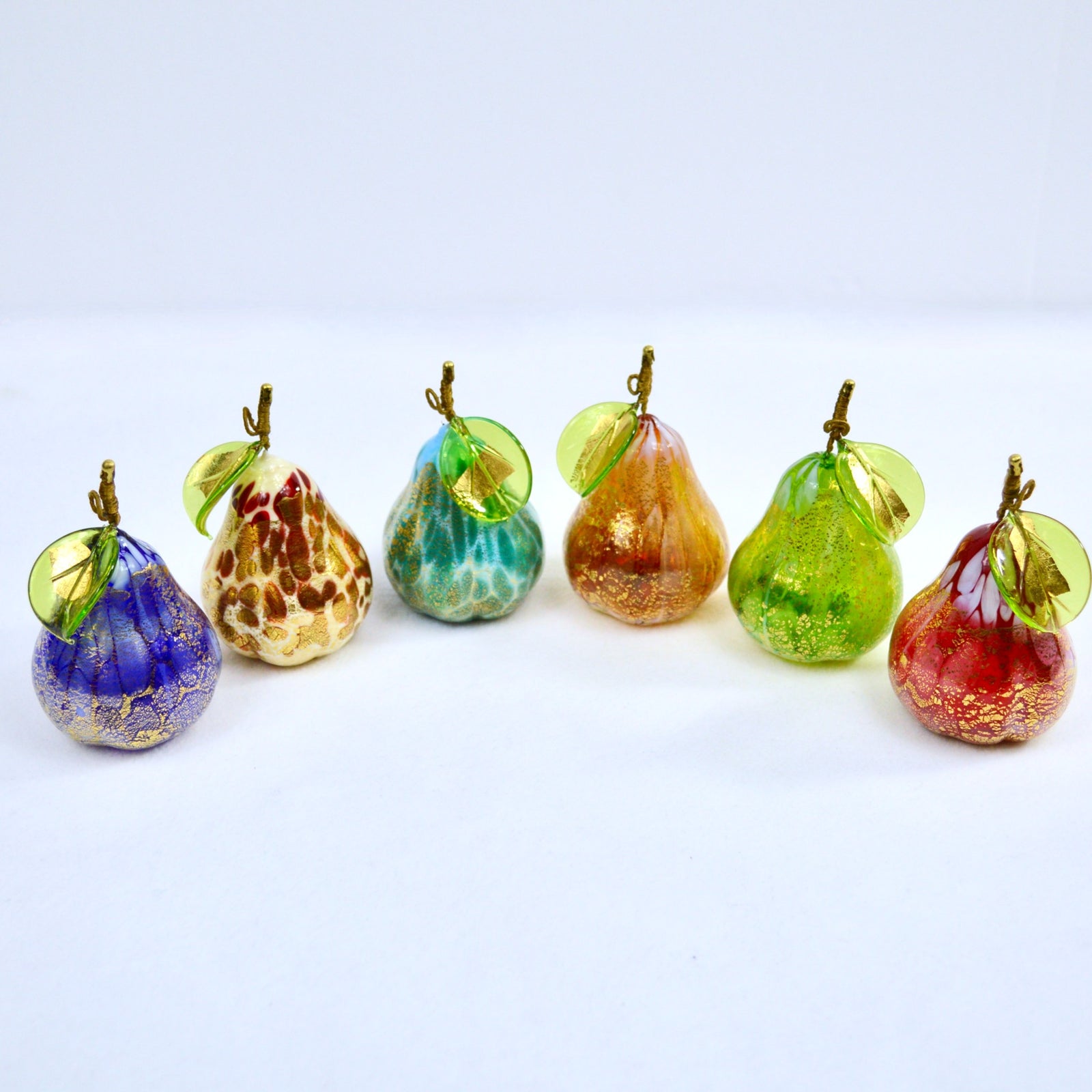 Hand-blown Murano Glass Macchia Pear with gold foil, artificial floral decor by My Italian Decor on a plate.
