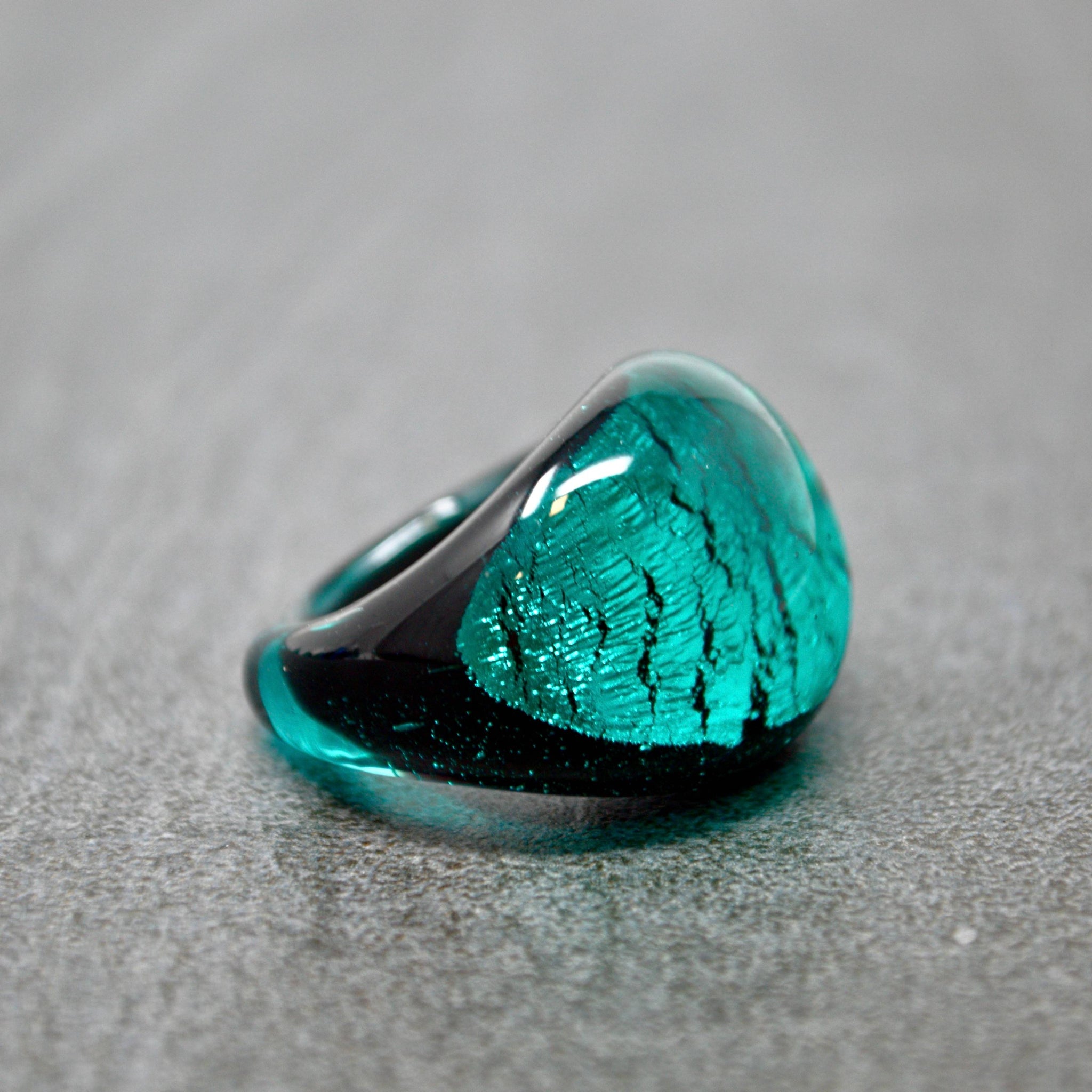 Close-up of Murano Glass Arno statement ring in teal and cobalt with silver accents, crafted in Italy.