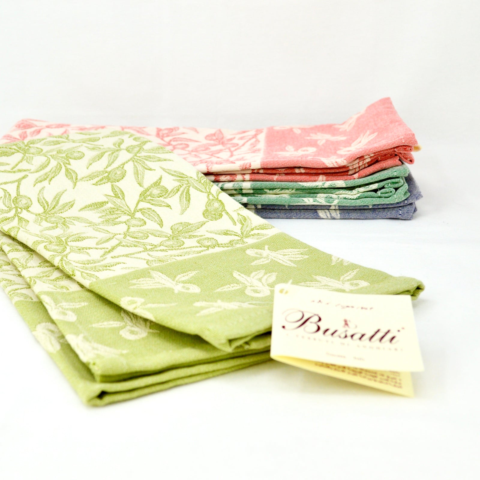 Colorful Busatti Oliva kitchen towel set from My Italian Decor, made in Italy, featuring vibrant assorted hues for stylish table linens.