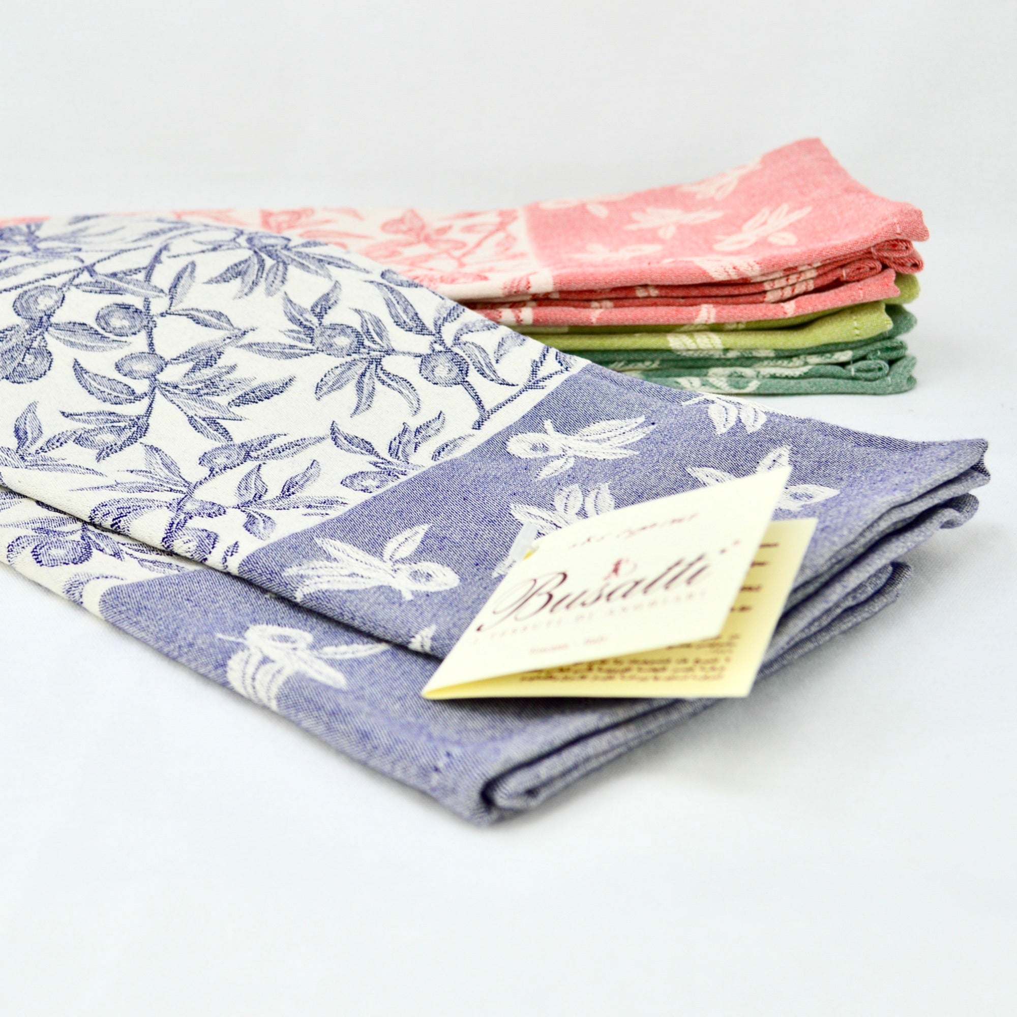 Busatti Oliva kitchen towel in assorted colors, made in Italy, showcasing vibrant woven linen with intricate patterns for elegant table linens.
