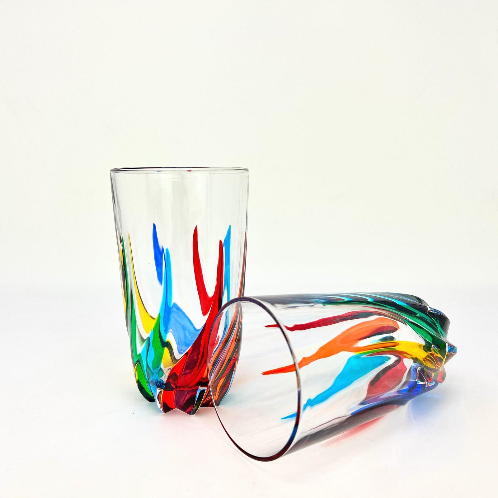 Two tall DZ Trix drinking tumblers with clear glass and smooth rims, made in Italy, showcasing their sleek, modern design.